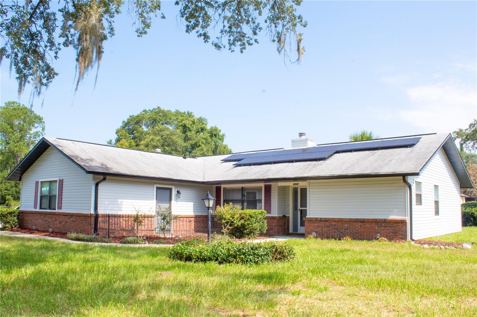 Beautifully updated 3BR/2BA home situated on a spacious 0.37-acre corner lot in Ocala! This move-in-ready residence features a bright, open-concept living space perfect for entertaining. The stunning, fully renovated kitchen boasts brand-new cabinets, premium granite countertops, and an open breakfast bar overlooking the main living area. Upgrades flow throughout the home, including brand-new flooring and a completely remodeled primary bathroom with a modern new shower and vanity. Enjoy convenient energy efficiency and massive utility savings with recently installed solar panels (2023) resting on a young roof (2021). Additional features include a dedicated indoor laundry room with washer/dryer hookups leading to a spacious, attached 2-car garage. Great location with plenty of outdoor space on an oversized lot. Schedule your private showing today!