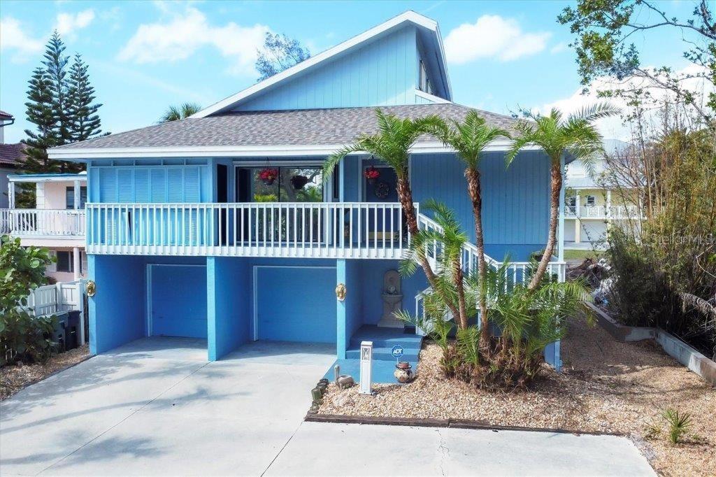 Virtually Staged. Seller is motivated! Discover the chance to own a meticulously maintained 4-bedroom, 3-bathroom home in Roberts Point—one of North Siesta Key’s most sought-after neighborhoods. This versatile two-story property is ready for you to move in, renovate, or rebuild into your dream retreat.  Designed with entertaining in mind, the home offers multiple outdoor decks and living spaces, plus a relaxing hot tub overlooking the tranquil bayou. The property has water access to the bay and beyond. The main living area on the second floor features an open, airy layout with vaulted ceilings, while the ground level includes a two-car garage, private 1-bedroom/1-bath suite, bonus room, and screened lanai—perfect for guests or extended family. Recent upgrades provide peace of mind, including a new roof (August 2023), hurricane shutters, and completed storm remediation. Surrounded by lush Florida landscaping, you’ll enjoy the serenity of the water while being just minutes from Siesta Beach, shopping, and dining. Don’t miss this exceptional location—whether you envision updating, expanding, or starting fresh, this is your opportunity to own a slice of paradise on Siesta Key.