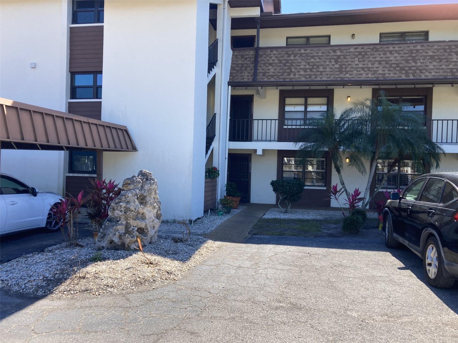 This is an extremely nice spacious second floor three bedroom-two bath turnkey furnished condo located in the 55+ community of Timber Creek.  The condo has been updated with porcelain tile floors through out and a beautifully remodeled kitchen.  The kitchen features Granite countertops, white cabinets,  stainless steel appliances, wine cooler and pantry with slide out drawers - and lots of counter space!  The kitchen also has recessed ceiling with can lighting and ceiling fan. The master bedroom is very large, 20x11, and the master bathroom has been updated with walk-in shower, dual sinks and a large walk-in closet.  There are two other bedrooms and an updated second bath - one bedroom has a walk-in closet.  There is large glass/screen enclosed lanai, 396 square feet,  with storage closet housing a full size washer and dryer.  Very quite setting, located at the back of the community and across from one of the greens and fairway.  There is an elevator in the building. Carport. Roof new in 2023. The community has a clubhouse with two kitchens, library, billiard room, gathering room and exercise room.  There is a heated pool and spa, tennis court, pickleball court and shuffleboard.  Plus there is a 9 hole par 3 golf course.  The complex is close to restaurants, groceries and shopping and about 5 miles to the beach.