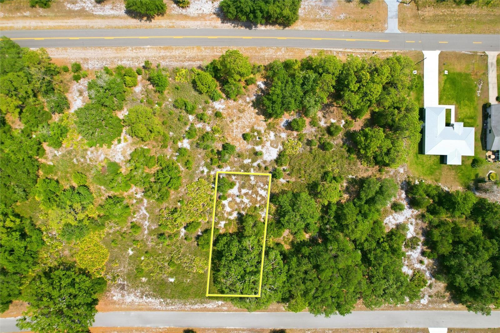 Discover the tranquil Florida lifestyle you've been seeking on this beautiful lot in Lake Placid. Imagine building your custom home away from the city' noise, where days are spent relaxing, fishing, or boating on nearby Lake June. This property offers convenient access to Sebring, just 20 minutes north, for big-box stores and diverse dining options. Enjoy the peace of Highlands County, centrally located just two hours from Florida's stunning coastal beaches, Orlando, Fort Lauderdale, and Tampa. A recent survey is available, and the lot is clearly marked for easy visibility, making your dream home a reality sooner.