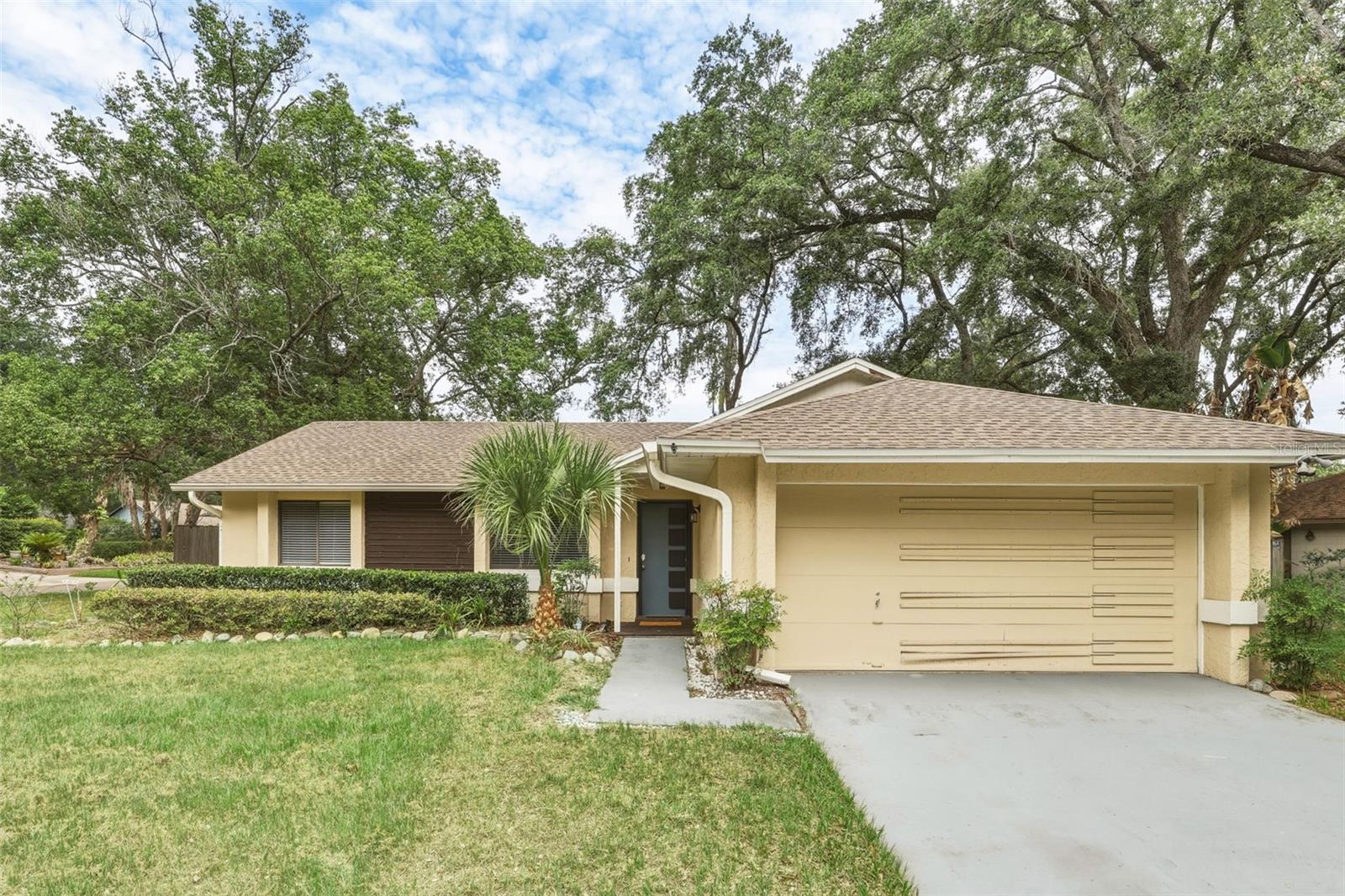 Welcome to this beautifully maintained 3-bedroom, 2-bathroom home located on a spacious .23-acre corner lot in the quiet, well-kept neighborhood of Riverside Park. NO HOA! Offering 1,134 sq ft of thoughtfully designed living space, this home features a split floor plan, ideal for both privacy and functionality. Step into a bright, airy interior with vaulted ceilings, crown molding, and ceiling fans throughout. The combined living and dining area creates a seamless flow, enhanced by blinds throughout, and elegant French doors leading to a spacious screened-in lanai. The updated kitchen is a chef’s delight, featuring crisp white cabinetry, stainless steel appliances, recessed lighting, a cozy eating area, and a closet pantry. Retreat to the private primary suite, complete with a coffered ceiling, ceiling fan, and an en-suite bathroom, a luxurious glass block walk-in shower with dual shower heads, including a rainfall shower and hand-held wand. Enjoy true Florida living in the large, fully fenced backyard with a fire pit, putting green, and an outdoor shower—ideal for entertaining or relaxing in your own private oasis. Additional highlights include a hall bathroom that was tastefully updated in 2024, a brand-new washer(2025) and dryer are also included and a two-car garage with a new motor. Located in quiet Riverside Park with sidewalks and a nearby playground. Just minutes from SR 414, I-4, and downtown Orlando. Shopping, dining, and everyday conveniences all close by. A rare find with exceptional outdoor features! Don't miss an opportunity to make this home your own! Roof - 2021 HVAC - 2019 Water Heater - 2020 Septic Drain Field Replaced - 2021 Septic Tank Pumped - 4/2025