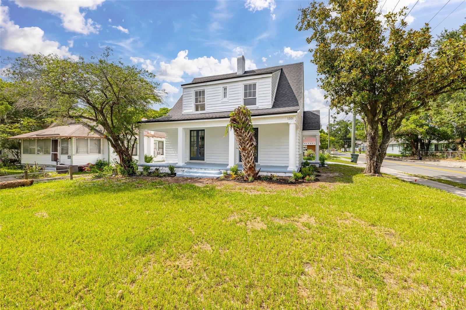 Welcome to Your Home Sweet Home! Step into the perfect blend of timeless character and modern comfort at 1201 Oakhill Street in Lakeland. This beautifully renovated 1930s two-story home has been thoughtfully reimagined into a spacious 3-bedroom, 2-bathroom residence while preserving the charm and craftsmanship that make historic homes so special. The inviting open-concept floor plan creates a bright and welcoming living space, ideal for both everyday living and entertaining. The primary bedroom is conveniently located on the main floor, offering privacy and ease of living, while the additional bedrooms upstairs provide comfortable accommodations for family, guests, or a home office. The stylish kitchen features stainless steel appliances, ample cabinetry, and flows seamlessly into the living and dining areas. Laminate wood flooring throughout adds warmth, durability, and a cohesive modern touch. Outside, you'll love relaxing on the large side porch, perfect for enjoying your morning coffee or unwinding in the evening. The home also offers a covered carport and driveway, a detached storage and laundry room, and sits on a desirable corner lot with plenty of outdoor space. With its new look and old-world charm, this move-in-ready gem offers the best of both worlds in one of Lakeland's established neighborhoods. Don't miss your opportunity to make this charming home your own. Schedule your private showing today and make 1201 Oakhill Street your Home Sweet Home before it's gone!