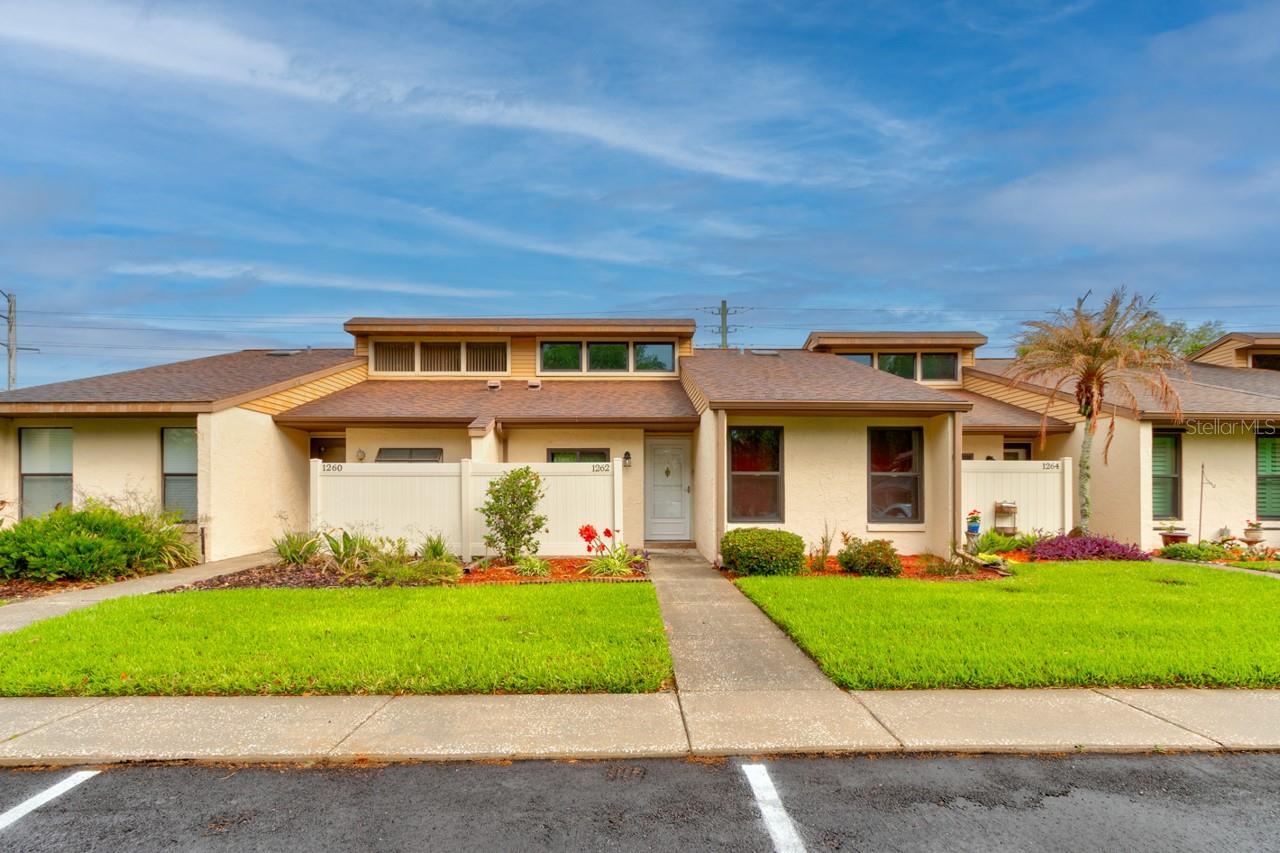 Affordable, move-in-ready Florida living awaits in this spacious 2-bedroom, 2-bath, single-level townhome-style condominium located in a quiet, well-maintained community. With no stairs, the home offers comfort, convenience, and easy everyday living. The bright great room features vaulted ceilings and skylights that create an open, airy atmosphere, with a natural flow into the dining area and kitchen. An enclosed Florida room provides valuable additional space for relaxing, hobbies, or a home office, along with a private storage closet. The home also features inside laundry with the washer and dryer included. Residents enjoy a community clubhouse and swimming pool, all with an affordable monthly association fee. Conveniently located near major shopping, dining, medical services, and area attractions. An excellent choice for a primary residence, seasonal Florida retreat, or low-maintenance home.