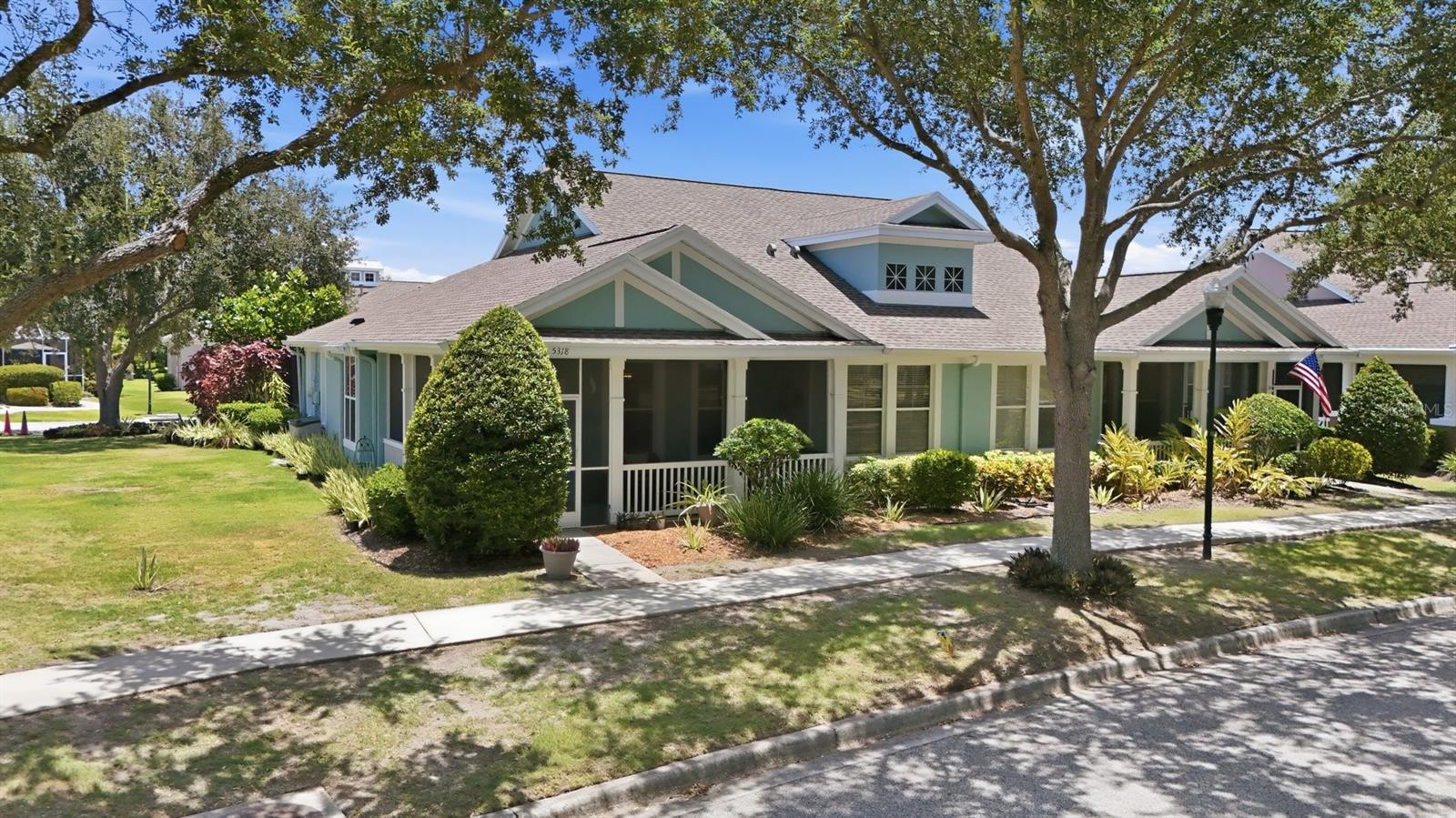 Welcome to your coastal paradise at 5318 Golden Isles Drive, nestled in the coveted Seacrest neighborhood of MiraBay — one of Tampa Bay’s most sought-after gated resort communities. Imagine waking each morning to the gentle Florida breeze, coffee in hand on your private screened front porch, with nothing on the agenda but deciding which resort amenity to enjoy first. That dream is daily life in this stunning, fully updated maintenance-free villa, positioned on one of Seacrest’s largest lots directly across from a serene greenspace park — yet still just a short, easy walk to the MiraBay Club and all it has to provides. This is not a “just needs a little TLC” listing. Every major system and surface has been thoughtfully upgraded with high-end finishes and quality materials. The new roof and fresh exterior paint give the home exceptional curb appeal, while inside, a new AC system, new hot water heater, whole-home water treatment system, and all-new appliances — including the washer and dryer — mean everything is done and done right. Custom lighting and ceiling fans have been installed throughout, and a beautiful paver walkway completes the picture. No deferred maintenance, no hidden surprises — just pure, carefree enjoyment from the moment you move in. The heart of this home is a showstopping chef’s kitchen that blends beauty with everyday function. All-wood custom cabinetry, premium upgraded appliances, and a dual-fuel convection oven set the stage for everything from casual weeknight dinners to holiday entertaining. A charming built-in dining booth anchors the breakfast area, while the open breakfast bar flows seamlessly into the great room — keeping the conversation going whether you’re cooking or hosting. A separate formal dining area stands ready for special occasions, making this floor plan as versatile as it is beautiful. Expansive teak porcelain tile flows throughout the open, split-bedroom floor plan, creating a light, bright, and airy coastal feel from the moment you step inside. The screened rear lanai extends your living space outdoors, giving you a peaceful spot to unwind or entertain year-round — a true hallmark of Florida living at its best. Retreat to your private master suite at the end of every day. The master bath has been completely reimagined with custom cabinetry, generous storage, dual sinks, and a luxurious walk-in shower featuring dual shower heads, built-in seating, and gorgeous designer tile. Every detail has been attended to. The guest bath has been equally transformed with quality fixtures, refined cabinetry, and sleek glass bath doors — your guests will feel right at home.Step outside your front door and into a community that most folks only experience on vacation. The MiraBay Club delivers resort-style pools with a waterslide, a 24-hour fitness center, a clubhouse, a waterfront café, tennis and pickleball courts, basketball courts, playgrounds, and miles of scenic walking and biking trails. The crown jewel is a stunning 135-acre lagoon complete with community kayaks and paddleboards — an amenity unlike anything else in the area. And because the HOA covers lawn care, landscaping, exterior pest control, irrigation, exterior painting reserves, and roof reserves, your weekends are completely and truly your own.
This isn’t just a home. It’s the life you’ve been working toward. Come see it for yourself.