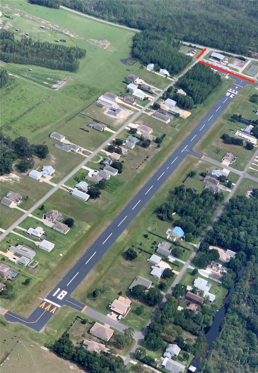 Pilot Country Airport, all parcels totaling approx 34.4 acres in a spectacular location.  Pilot Country Airport represents a rare opportunity to acquire a fully operational, privately owned, public-use airfield and established residential airpark in Pasco County, Florida—strategically positioned along the rapidly expanding State Road 52 corridor within the high-growth Tampa Bay region.  This asset combines proven aviation infrastructure, consistent in-place income, and significant development upside, creating a compelling opportunity for both aviation operators and real estate investors. With increasing regulatory barriers, zoning constraints, and land scarcity, new airport development in this region is extremely limited, making existing, licensed airfields highly defensible and effectively irreplaceable assets. The airport features a paved runway (18/36) measuring approximately 3,700 feet long by 75 feet wide, suitable for a wide range of general aviation aircraft. The runway was resurfaced in 2020, and the full lighting system was upgraded the same year, providing reliable pilot-controlled lighting for safe nighttime operations. Recent capital improvements further enhance operational capacity and revenue potential. A newly constructed (2024) 100’ x 100’ box hangar with a large fold-up door provides modern, high-demand storage for larger aircraft. A recently refurbished shade hangar accommodates up to 14 aircraft, complemented by approximately 10 outdoor surface tie-down positions. Notably, both hangar space and tie-down positions are consistently 100% occupied, underscoring strong demand and providing immediate, stable income with clear mark-to-market upside.  The airport is equipped with 24/7 self-service 100LL fuel, supporting both based tenants and transient traffic. This existing infrastructure provides a strong foundation to scale fuel sales and expand aviation services, including maintenance, avionics, and flight operations—unlocking additional high-margin revenue streams. From an operational standpoint, the airport benefits from a favorable airspace position—located outside of congested controlled airspace while maintaining convenient access to the Tampa Bay metro area. This allows for efficient, less restricted operations, a key advantage for both recreational and business aviation users.
The property also offers significant real estate and development potential. Approximately 10.34 acres of frontage along State Road 52 are zoned C-2 commercial, allowing for a wide range of uses, including aviation-related services, flex industrial, retail, or mixed-use development. The frontage can be configured in multiple ways, providing flexibility for a full-site acquisition or partial sale strategy. The location is a major driver of long-term value. State Road 52 is currently undergoing significant widening and infrastructure improvements, transforming it into a primary east-west corridor across Pasco County. The property is located less than 10 minutes from the new Moffitt Cancer Center Pasco County campus, a major regional healthcare and employment hub expected to catalyze substantial residential and commercial growth. Value-add and expansion opportunities include: Development of additional hangars (T-hangars, executive hangars, or hangar condominiums); Expansion of tie-down and aircraft storage capacity; Scaling fuel operations and introducing additional aviation services; Commercial development along SR-52 frontage and more!