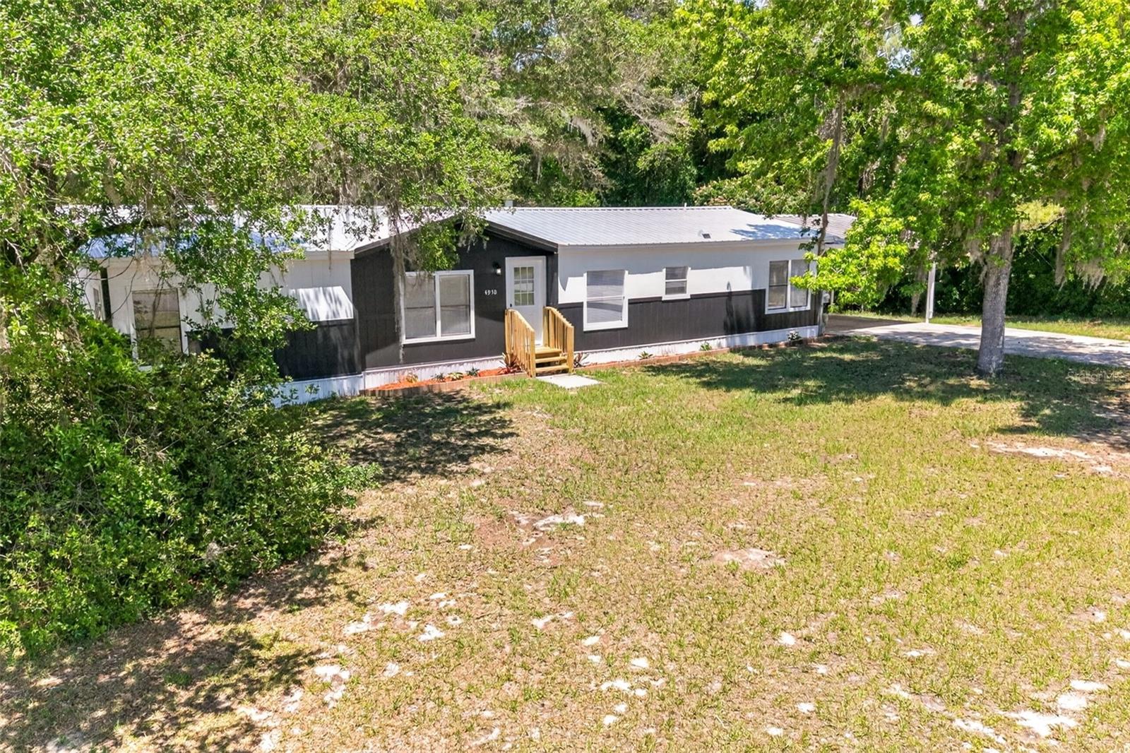 Completely remodeled and move-in ready! This modern and charming 3 bedroom, 2 bathroom manufactured home sits on an impressive 1.16 acre lot with NO HOA, giving you the space and freedom buyers are searching for. Inside, you’ll find new flooring, new AC, fresh paint, remodeled bathrooms, a beautifully updated kitchen, along with updated plumbing and electrical for added peace of mind. The home offers a bright and inviting feel with stylish modern finishes throughout. Relax and enjoy the Florida weather from the screened porch, or take advantage of the covered carport located on the side of the home. The roof was replaced in 2020, making this property even more attractive for buyers looking for a well-maintained home with major updates already completed. Properties with this much land, modern upgrades, and no HOA are becoming harder to find. Don’t miss your opportunity to own this move-in ready property before it’s gone—schedule your showing today!
