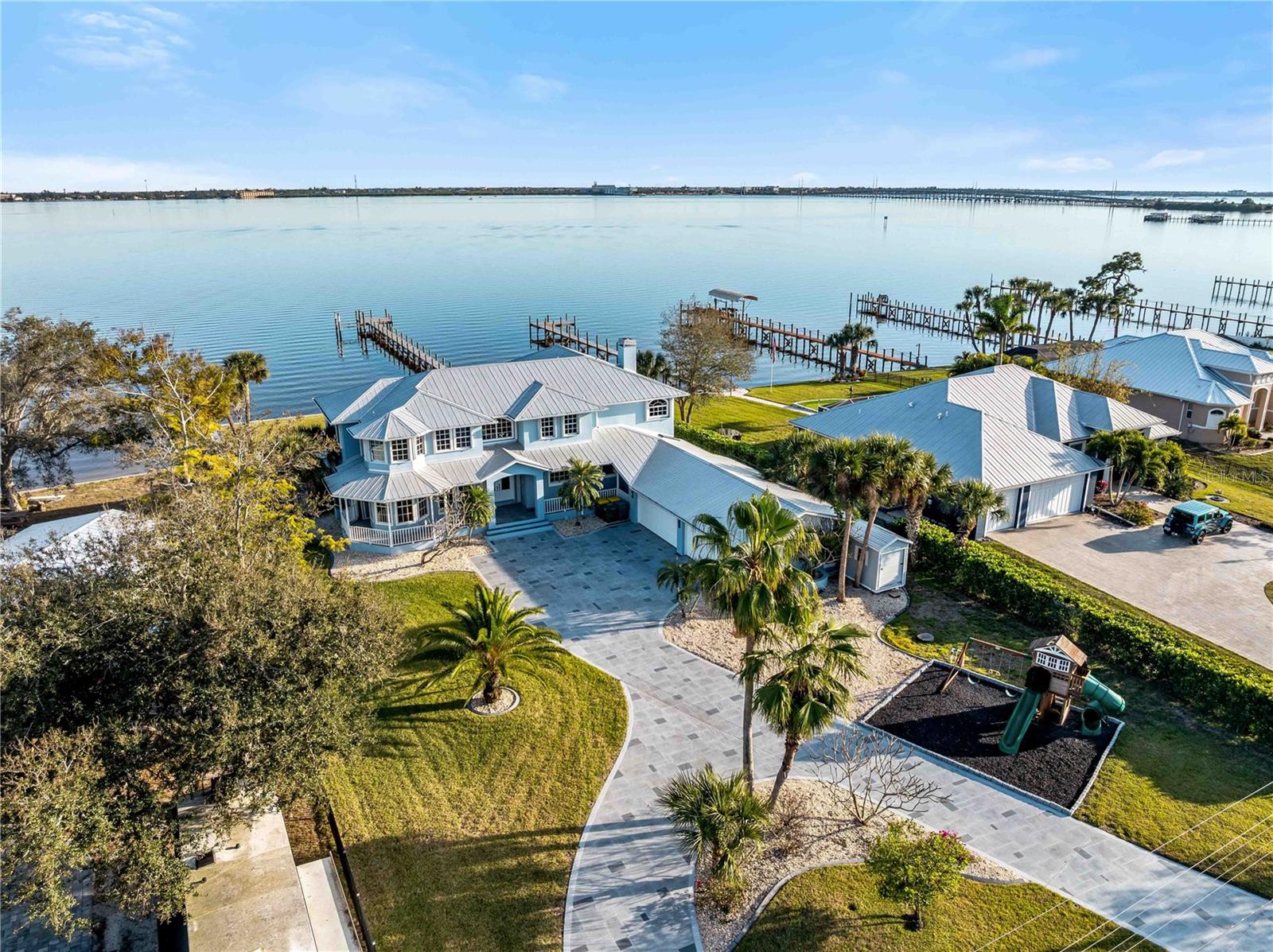4430 North Shore Drive — Rarely available waterfront estate with sweeping river and harbor views, private dock and direct boating access. Built by Sorrentino, this elegant residence sits on a lush 0.53-acre lot and offers 4 bedrooms + large office/bedroom with closet, an attached 1-bed/1-bath in-law suite, 4 full baths and 1 half bath, and an oversized 4-car garage.

The recently renovated first floor features an upgraded kitchen with new cabinetry, granite counters, stainless appliances and a large pantry. The spacious living area centers on a fireplace and flows to outdoor living and pool areas. The in-law suite has a separate exterior entrance (also accessible via the laundry area), a kitchenette, breakfast nook and walk-in closet.

Upstairs includes two master suites, each with walk-in showers and garden tubs; one suite opens via French doors to a balcony overlooking the harbor, pool and river. Practical touches include laundry chutes and a convenient second laundry area.

Outdoor amenities are exceptional: a newly renovated 20' x 40' pool with large spillover spa and swim-spa jets, a 200' renovated dock with a 10,000 lb boat lift, and mature tropical landscaping. A separate well and dedicated irrigation system fully cover the front, side and rear lawns for easy, cost-effective landscape maintenance. Recent updates include a new metal roof (2023), newer HVAC systems and a mini-split in the in-law suite. The property is wind protected with a combination of hurricane-impact windows/sliders and shutters. An automated gated front entrance adds privacy and security.

Prime location — minutes to downtown Punta Gorda, I-75 and Sunseeker Resort. This move-in ready riverfront home on North Shore Drive is a rare find. Schedule your private showing today. This home could be well suited as a seasonal rental and or investment property as well with the ability to rent the in law suite out separate.