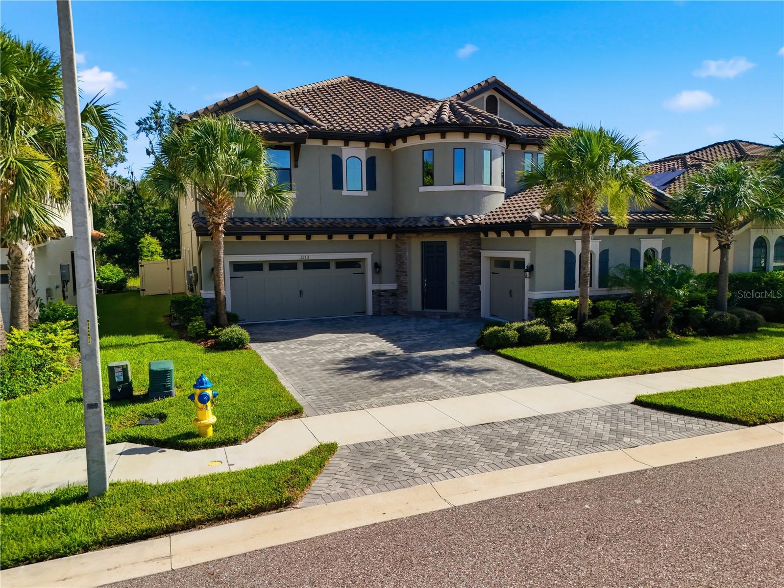 Welcome to this stunning WestBay Madeira III home with European Country elevation in the gated community of Pristine Lake Preserve in Land O’ Lakes. Built in 2022, this exceptional residence offers 4,218 sq ft of living space, 5 bedrooms, 4.5 bathrooms, a private office, formal dining room, upstairs bonus room, and a 3-car garage. Situated on a premium homesite backing to a dense conservation area, the home provides exceptional privacy with peaceful natural views and no rear neighbors.

Designed for luxury Florida living, the backyard features a 28’ x 14’ saltwater pool and spa, expansive paver deck, and two-story screened enclosure overlooking the private wooded backdrop. The oversized covered lanai and full-width sliding glass doors from the Great Room and Bonus Room create seamless indoor-outdoor entertaining spaces. A spacious covered second-floor balcony, accessible from both the owner’s suite and bonus room, offers the perfect setting for morning coffee or evening relaxation.

The gourmet kitchen showcases custom-designed cabinetry with symmetrical layout, built-in wine glass rack, oversized quartz island with extended seating, stainless steel appliances, 36-inch gas cooktop, full-height decorative backsplash, and designer lighting. The upstairs bonus room includes a wet bar and beverage center, ideal for gatherings, movie nights, or entertaining.

Additional upgrades and features include 10-foot ceilings and 8-foot interior doors on the main level, full-width sliding glass doors, high-efficiency Carrier HVAC with enhanced humidity control, natural gas tankless water heater, laundry room with cabinetry and utility sink, whole-house water softener, underground gutter drainage system, built-in pest control piping, concrete block first-floor construction, and remaining builder structural warranty.

Located in Pristine Lake Preserve, residents enjoy a gated community with low HOA fees ($160/month), no CDD fees, and convenient access to highly rated schools, shopping, dining, entertainment, hospitals, and major roadways. Curve Lake is within walking distance, adding to the community’s peaceful natural setting.

This better-than-new Madeira III offers the perfect combination of luxury finishes, privacy, resort-style outdoor living, and modern upgrades in one of Land O’ Lakes’ most desirable communities.

Schedule your private tour today and discover one of the finest homes available in Land O' Lakes.