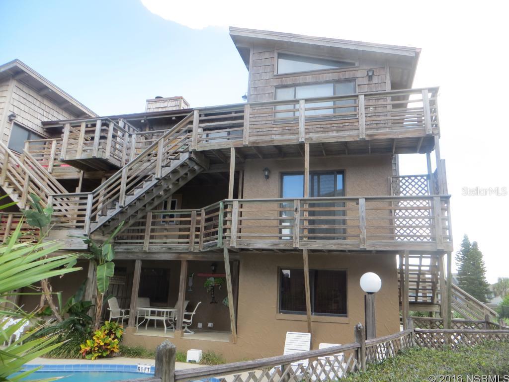 Oceanviews from this spacious townhome in desirable Sea Dunes, PIECES OF EIGHT.  Three stories with separate balconies. First level has a double car garage, laundry area and entrance to a private patio area overlooking the pool. Second level has a private entrance and features a full kitchen, living room/diningn area, two bedrooms and one bath with patio with view of the ocean and the pool. Third level has a private entrance and features a full kitchen, two bedrooms and two baths, spacious living room/dining area with fireplace, balcony with view of the ocean and the pool. Amenities include a tennis court, swimming pool and private walkway to the beach that is shared by nine other Pieces of Eight owners. No diving on the beach area.Association fee paid semi-annually ($1,000). Come enjoy the charm and natural beauty of New Smyrna Beach! ;Water: City