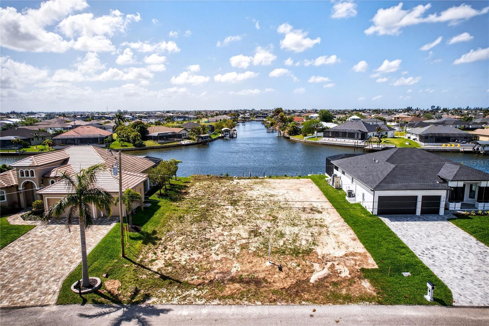 PRICED TO SELL! NEWER SEAWALL, CANTILEVER DOCK, LOOONG CANAL VIEW PLUS INTERSECTING CANAL VIEW ;) - A VERY RARE OPPORTUNITY! LONG CANAL + INTERSECTING CANAL VIEWS on the desirable HORSESHOE CANAL with over 160’ of water frontage view and an EXPANSIVE INTERSECTING CANAL perspective exceeding 250’ ft, creating a TRULY UNIQUE and ELEVATED WATERFRONT SETTING RARELY AVAILABLE IN Cape Coral PARADISE :) This DIRECT GULF ACCESS lot offers 80 ft x 125 ft (10,000+ sq ft) and features a NEWER SEAWALL (2024), a major value add saving time and significant construction costs! ENJOY WIDE WATER VIEWS and EXCEPTIONAL NATURAL LIGHT from this PREMIUM HOMESITE surrounded by newer construction residences. BOATING ENTHUSIASTS will appreciate GULF ACCESS via ONE BRIDGE (approx. 8’9” clearance) with access through the NORTH SPREADER WATERWAY to Pine Island Sound, Cayo Costa, Boca Grande, North Captiva, and Sanibel Island, offering WORLD-CLASS BOATING, FISHING, WATERFRONT DINING, ISLAND HOPING, and UNFORGETTTABLE SWFL SUNSETS! The SOUTH REAR EXPOSURE provides optimal sunlight throughout the day, ideal for designing a LUXURY POOL, SPA, OUTDOOR KITCHEB, and ENTERTAINING SPACE with WARM WINTER SUN and VIBRANT YEAR-ROUND BRIGHTNESS. Plenty of space to build your CUSTOM HOME with DOCK, BOAT LIFT, TIKI-HUT, CAPTAIN WALK, and other WATERFRONT LIFESTYLE FEATURES, PERFECT FOR ENJOYING FISHING FROM YOUR BACKYARD or LAUNCHING YOUR NEXT COASTAL ADVENTURE! Located near Burnt Store Rd and NE Pine Island Rd, offering convenient access to dining, shopping, golf courses, marinas, parks, and everyday essentials, with seamless connectivity north to Punta Gorda, Venice, and Sarasota or south to Fort Myers, Bonita Springs, Naples, and Marco Island. Located just minutes from the highly anticipated Seven Islands waterfront development, planned to feature marinas, dining, recreation, and resort-style amenities, further enhancing long-term value and lifestyle appeal. SWFL International Airport (RSW) AND Punta Gorda Airports (PGD) are within 30 miles reach, offering easy access for regional and seasonal travel! Ideally positioned for travel and adventure, with convenient access to major cruise ports including Port Miami, Port Everglades, and Port Tampa Bay, perfect for spontaneous GETAWAYS and WORLD-CLASS CRUISING. BUILD YOUR DREAM HOME OR INVEST IN ONE OF CAPE CORAL'S MOST DESIRABLE WATERFRONT AREAS! THIS IS WAY MORE THAN A LOT!!! IT IS A LIFESTYLE OPPORTUNITY DEFINED BY BOATING, SUNSHINE, AND COASTAL LIVING AT ITS FINEST :)