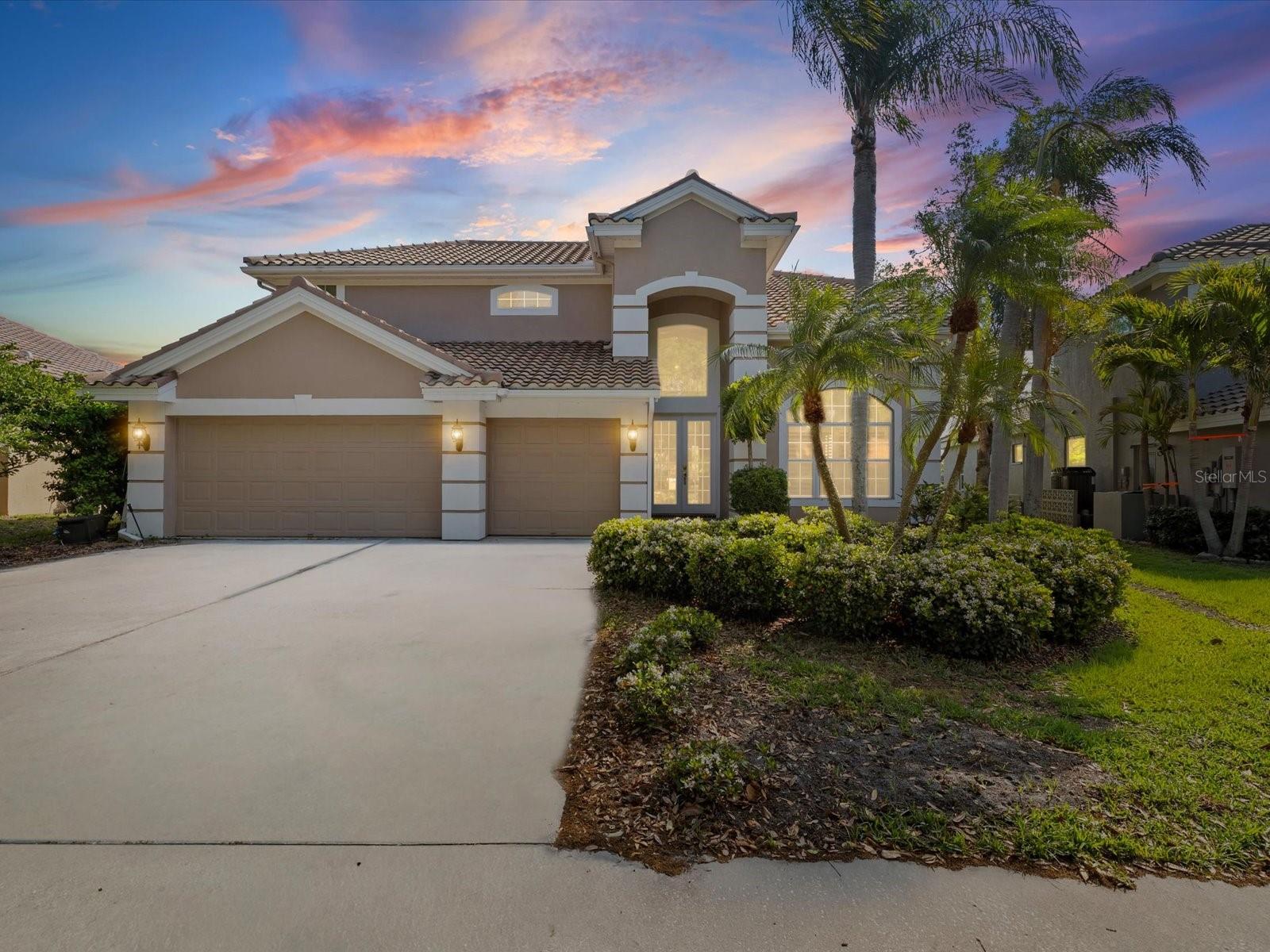 One or more photo(s) has been virtually staged. Welcome to the exclusive, gated community of The Bayou Club, where luxury living meets resort-style amenities. This home features a brand-new roof and an oversized 3-car garage, perfectly designed to accommodate two vehicles plus a golf cart. Step through the grand double-door entry into a stunning foyer with soaring ceilings and abundant natural light. Designed with both comfort and entertaining in mind, the home offers a versatile floor plan that includes two spacious living areas, a formal dining room with coffered ceilings, and a charming breakfast nook. The expansive chef’s kitchen is a true centerpiece, featuring a double oven, gas range, ample cabinetry, and a large island with seating for four. The inviting family room boasts a cozy gas fireplace and sliding glass doors that open to your private outdoor oasis. Enjoy serene pond views from the pool and spa—perfect for watching the sunrise with your morning coffee or hosting unforgettable evening gatherings. The luxurious owner’s retreat offers tray ceilings, his and hers walk-in closets, and a spacious en-suite bath complete with soaking tub, walk-in shower, and dual vanities. On the opposite side of the home, a private bedroom with double-door entry and dedicated bath provides the ideal space for a home office or guest suite. Nearby, a large indoor laundry room leads directly to the garage. Upstairs, you’ll find three generously sized bedrooms with ample closet space, along with an updated bathroom featuring dual vanities. The outdoor living area is designed for convenience and entertainment, complete with a pool, jacuzzi, and a half bath. Additional highlights include abundant storage throughout—perfect for large families and seasonal décor—plus recent upgrades such as a newer gas tankless water heater, AC system, and energy-efficient LED lighting. Located outside of the flood zone and just minutes from shopping, dining, and everyday conveniences, this exceptional home offers the perfect blend of luxury, comfort, and location. Members enjoy access to a championship 18-hole golf course, elegant clubhouse with on-site dining, sparkling pool, tennis courts, pickleball, fitness center, and the peace of mind of a 24-hour guarded gate. This golf cart-friendly community offers the ultimate Florida lifestyle.