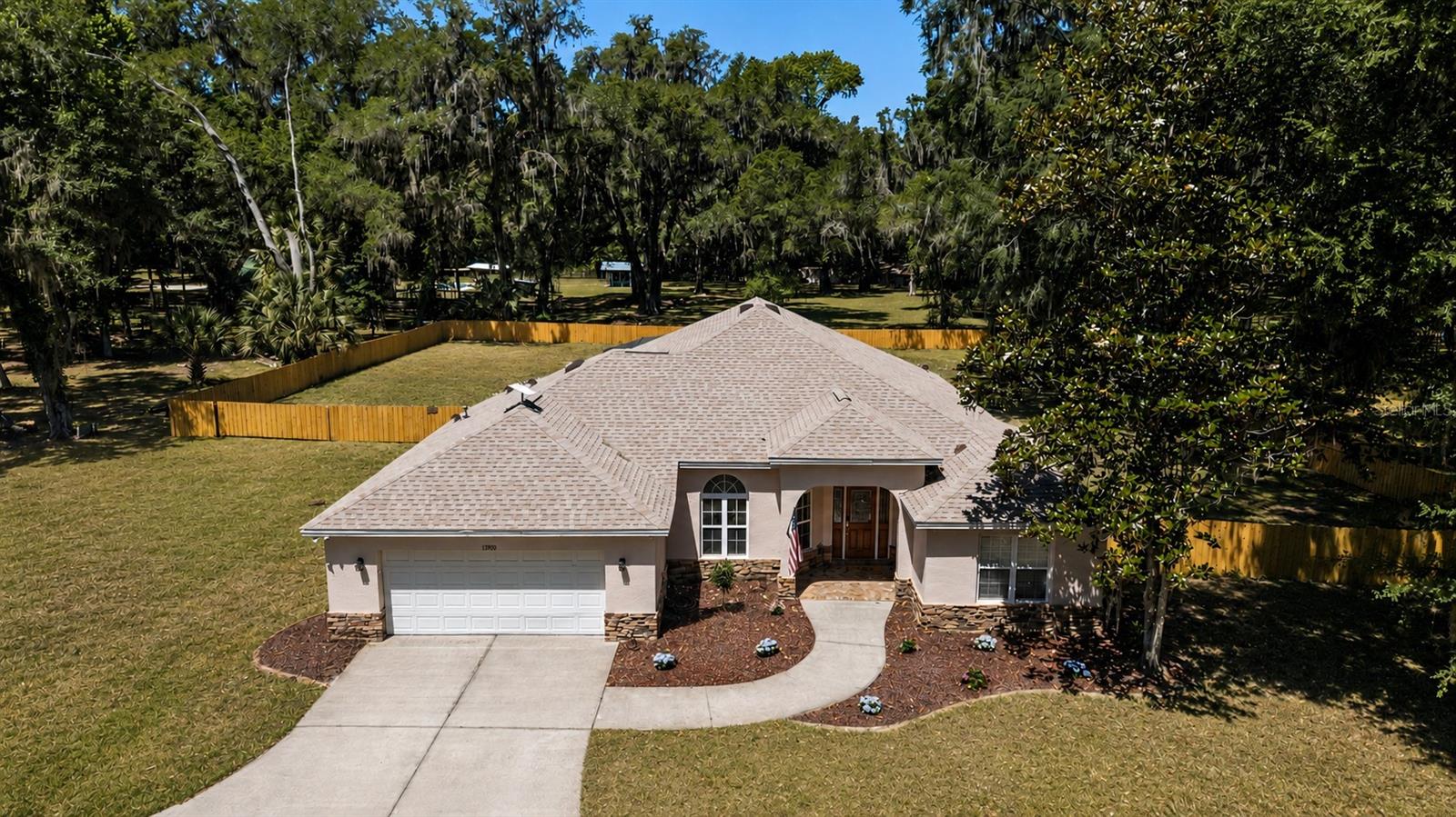 Welcome to this beautifully updated pool home located in the sought-after community of Meadowbrook Ranches in Anthony, Florida. Situated on an oversized 1.13-acre lot with a brand-new privacy fenced backyard, this stunning concrete block home offers the perfect blend of comfort, functionality, and modern updates with 2,272 square feet of living space and 3,767 total square feet under roof.
From the moment you arrive, the home’s stacked stone accents, fresh landscaping, and inviting curb appeal make a lasting impression. Inside, you’ll find a bright and open-concept floor plan designed for both everyday living and entertaining. New luxury vinyl flooring runs throughout the home, complemented by fresh interior paint, updated lighting, recessed lighting, and abundant natural light that enhances the spacious feel.
The beautifully updated kitchen features quartz countertops, freshly painted cabinetry, new fixtures and drawer pulls, new Samsung appliances, ample storage space, and an ideal layout for gathering with family and friends. Just off the kitchen is a convenient indoor laundry room for added functionality.
The spacious primary suite serves as a relaxing retreat with a luxurious en-suite bathroom featuring a large soaking tub, walk-in shower, and a stunning open glass panel between the tub and shower that creates an airy, spa-like atmosphere filled with natural light. Both bathrooms have been tastefully updated with new countertops, fresh painted cabinets and brand new fixtures.
Step outside and experience your own private backyard oasis. The brand-new 2026, 16x38 saltwater screened-in inground pool is the centerpiece of the outdoor living space, while the paved back porch and fully equipped outdoor kitchen make entertaining effortless. Enjoy peaceful evenings and some of the most beautiful sunset views from the backyard.
Additional upgrades and features include a 2024 roof, updated electrical, a propane generator, 50-amp RV plug, and a spacious 2-car garage.
Conveniently located just minutes from downtown Ocala, approximately 25–30 minutes to Gainesville, and with easy access to I-75 for commuting to Orlando and surrounding areas, this property offers the perfect balance of peaceful country living and accessibility.
This move-in-ready home in Meadowbrook Ranches is a rare opportunity to enjoy modern updates, outdoor living, and a prime Central Florida location all in one exceptional property.