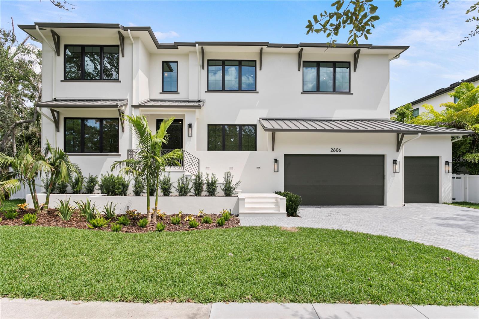 This newly constructed home is the product of a remarkable collaboration among three renowned South Tampa builders—Halo Homes, Hooter Construction, and Baylife Homes. Their collective skills have resulted in a luxurious residence that sets a benchmark for contemporary living in Sunset Park. The home was carefully designed using cutting-edge construction methods, including Two story block construction with no wood on exterior walls. 
Every detail throughout the property is meticulously executed. The professionally landscaped exterior offers a paver driveway, sleek stucco finish, 30-year dimensional shingle roof, bronze gutters, and a marble-accented front porch. Indoors, you'll find 10- to 10-foot 8-inch ceilings, , top-tier drywall finishes, and single-panel 8-foot solid core doors, all contributing to a refined ambiance. Engineered hardwood floors extend through the main areas, enhanced by elegant, coffered ceilings. The open-concept design centers around a spectacular kitchen equipped with custom cabinetry, level 6 quartz countertops, a full-height quartz backsplash, pot filler, and a professional Thermador appliance suite—cooktop, double ovens, a microwave drawer. A walk-in butler’s pantry adds practicality and sophistication, showcasing LED-lit white oak floating shelves and dual 24” beverage/wine refrigerators.
Seamless indoor-outdoor living is made possible by a 16’ impact-rated sliding glass door that opens onto a marble-clad lanai, which includes an outdoor kitchen with marine-grade cabinetry, Artisan gas grill, beverage fridge, stainless sink, and outdoor speakers. The backyard features a resort-style pool, spa, and sun shelf—ideal for entertaining any time of year.
A elevator provides access to all levels, The expansive primary suite offers soaring ceilings, a private beverage center, and a resort-inspired bathroom complete with dual vanities, designer marble accents, a soaking tub, spacious walk-in shower, and two built-in closet systems. Secondary bedrooms each come with their own walk-in closets and en suite baths. Additional spaces include a second-floor loft, laundry room, media room, and dedicated AV closet, Further amenities comprise two Navien tankless gas water heaters, high-efficiency Carrier HVAC systems controlled by Ecobee smart thermostats, Gyp-Crete fire and sound protection, and in-wall pest control tubes. The oversized four-car (two-car tandem) garage completes the package.
Step inside to experience a modern transitional interior where sophistication meets practicality. The open floor plan highlights engineered hardwood flooring, bespoke cabinetry, and Thermador appliances set beneath impressive high ceilings. Spacious common areas transition smoothly to a marble-covered lanai, leading out to the pool and large backyard that's ideal for quiet relaxation or social gatherings.
Perfectly nestled near top-rated schools and the best of South Tampa’s neighborhoods in Sunset Park close to airport, restaurants, and countless amenities, this residence is more than just a showcase of cutting-edge construction and fine materials—it’s a place where unforgettable memories are waiting to be made. With a harmonious blend of comfort, elegance, and enduring quality, this home is ready to welcome you for a lifetime of inspired living.