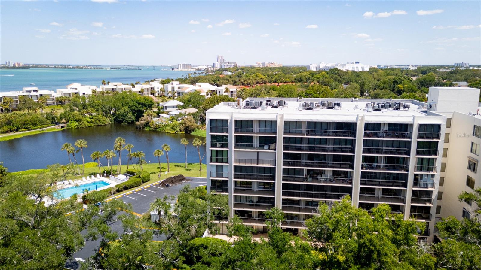 Luxury and relaxation located in a golf cart community in the Belleair Country Club golf course, this 6th-floor condo gives you the easy Florida lifestyle without the maintenance headache. Not only is it gated, its 24 hour security at the gate, along with video in the lobby for added security. A bonus perk - skip the wait list for the Belleair Country Club as an owner of one of the condos in this community. Inside, the open kitchen flows right into the living room, making the space feel connected and functional whether you’re relaxing at home or having people over. Step out to the large balcony and take in a view of the Gulf, with automatic blinds on the windows and sliders when you want privacy or shade. The unit also has impact windows and sliders, combined with automatic retractable/rolling storm shutters, in-unit laundry with your stackable washer and dryer, and a reverse osmosis water system already in place. Downstairs, you’ve got ground-floor storage plus under-building parking so you can stay out of the elements. Enjoy the heated and cooled pool year round, creating the perfect environment at any time.  All of it sits inside a gated community with a guard, in one of Belleair’s most convenient spots near the water, golf, and everything that makes this area so desirable.