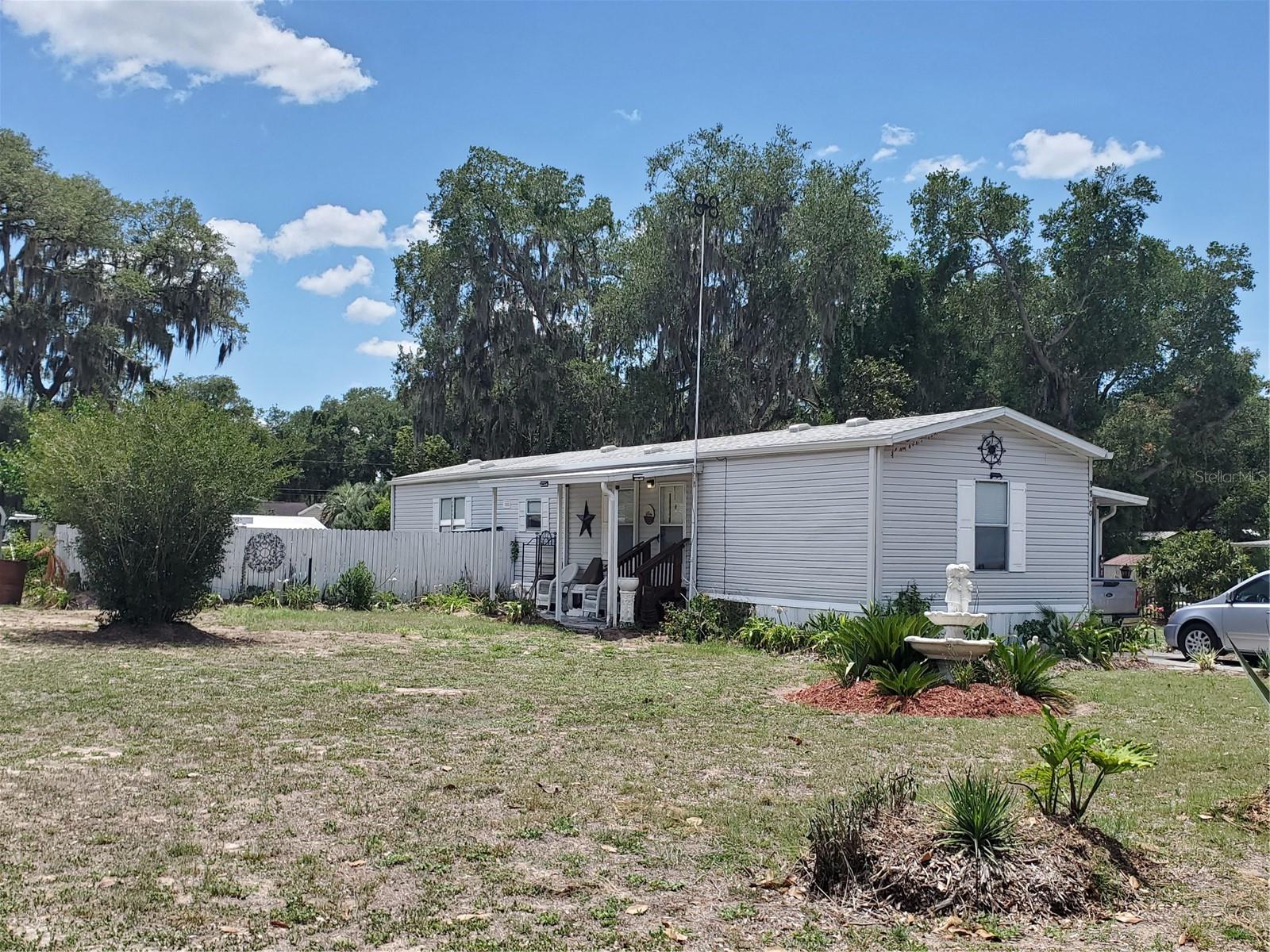 PRICE IMPROVEMENT!! Motivated Sellers!!Charming 2-bedroom, 2-bath split floor plan home built in 2006 with thoughtful upgrades and excellent features throughout including a NEWER ROOF 2023 and the HVAC replaced in 2020. This oversized lot is on a dead end street with hardly any traffic.  The home includes recently flushed air ducts (completed last year), a smart-wired smoke alarm system, updated ceiling fans and lighting, and an upgraded guest bathroom shower. Flooring includes elegant marble laminate for a stylish, low-maintenance finish. Outside, you'll find a spacious carport, two electric-equipped sheds for storage or workshop use, and beautifully maintained flowering trees that add curb appeal and seasonal color. A standout feature is the impressive storm shelter measuring approximately 13 feet deep by 8 feet wide, offering added security and peace of mind. This well-maintained property combines comfort, functionality, and preparedness with attractive indoor and outdoor living features. Close to the Villages with easy access to entertainment, shopping and great eats.  No HOA!!! Call and get a showing before it's gone!!