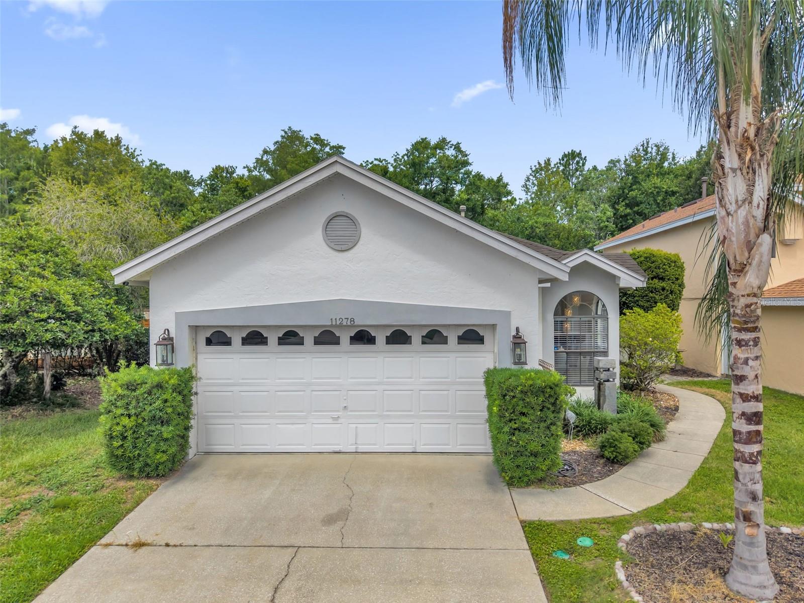 Welcome to this beautifully maintained Orlando home in the highly desirable Williamsburg area, perfectly tucked away on a quiet cul-de-sac with inviting curb appeal, bright living spaces, and a private outdoor retreat with no rear neighbors. Designed for comfortable everyday living and effortless entertaining, the open concept layout offers tile flooring through the main living and dining areas, abundant natural light, and an easy flow from the front entry into the heart of the home. The kitchen delivers a clean, modern feel with white cabinetry, stone countertops, stainless steel appliances, a breakfast bar, pantry storage, and a charming breakfast nook surrounded by arched windows, creating the perfect spot for morning coffee or casual meals. The primary suite provides a peaceful escape with wood-look flooring, a soft neutral palette, and a spa-inspired en suite bath featuring dual sinks, updated fixtures, illuminated mirrors, and a walk-in shower. Secondary bedrooms offer flexibility for guests, a home office, hobbies, or additional living needs. Step outside to enjoy true Florida living with a covered lanai, screened pool, paver pool deck, and a peaceful wooded backdrop that adds to the sense of privacy. Community amenities include a pool, clubhouse, fitness area, game room, playground, and tennis courts, all in a convenient Orlando location near shopping, dining, theme parks, major roadways, and area attractions.