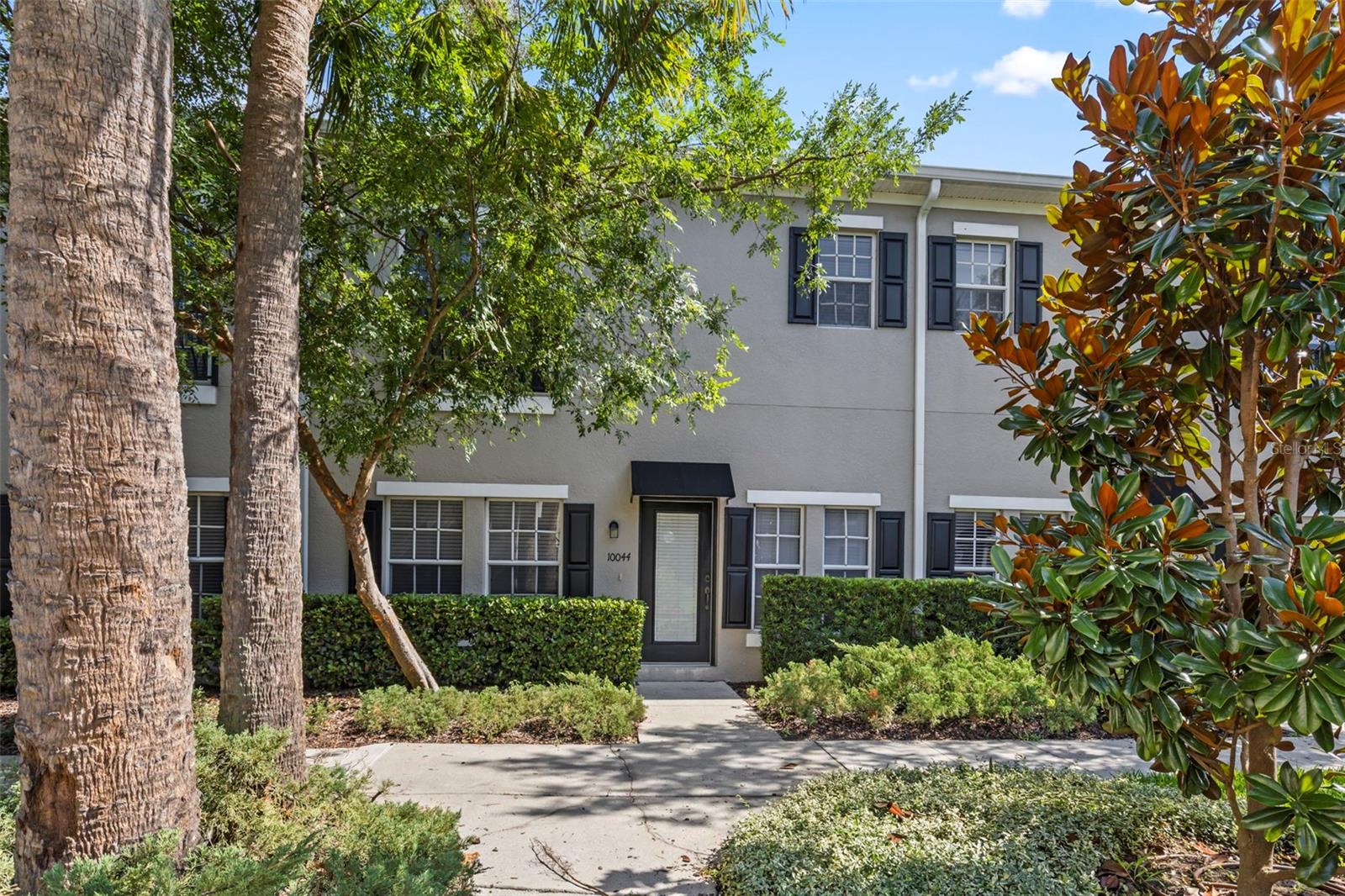 Virtually Staged. Twilight photo of front exterior is virtually enhanced. Beautifully updated townhome in the highly desirable On the Park community in the heart of Carrollwood! This move-in-ready home features a bright, open floor plan with fresh interior paint, stylish tile flooring throughout the main living areas, new bedroom carpeting, and brand-new kitchen appliances (all 7/26). A new roof installed in 2023 provides added peace of mind. The spacious kitchen offers a breakfast bar, pantry, built-in desk, and overlooks the living and dining areas—perfect for everyday living and entertaining. Upstairs, the generous primary suite features a walk-in closet and an en-suite bath with dual vanities, a soaking tub, and a separate walk-in shower. Bedroom 2 is upstairs as well with a full bathroom. The 2nd floor laundry closet includes the washer and dryer for added convenience. Additional highlights include a private attached two-car garage and a sparkling pool all in a beautifully landscaped park-like setting. This pristine and quiet community is conveniently located near shopping, dining, parks, major highways, Tampa International Airport, and downtown Tampa. Rarely available in one of Carrollwood's most sought-after communities—schedule your private showing today!