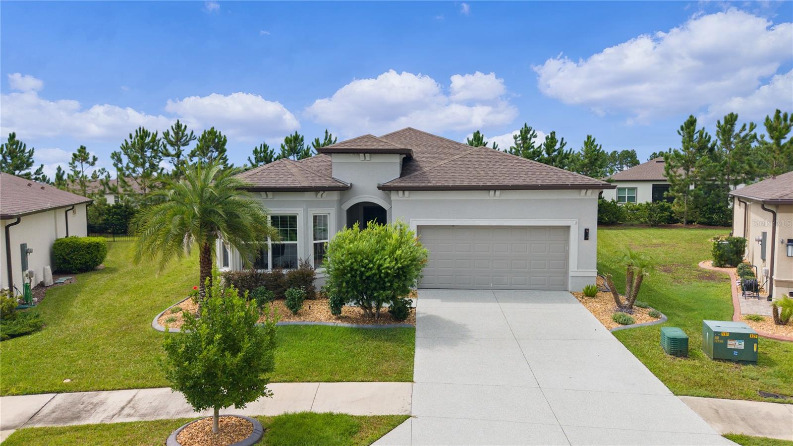 Auction Property. Auction! Bid what you want to pay.  
Modern Luxury Meets Low-Maintenance Living in Ocala!
Built in 2022, this beautifully designed 3-bedroom, 2.5-bath concrete block home offers over 2,100 square feet of thoughtfully designed living space, combining modern style, comfort, and functionality. From the moment you arrive, you'll appreciate the quality construction, spacious layout, and attached 2 car garage that make this home ideal for both everyday living and entertaining. 
Inside, you'll find an open and inviting floor plan with generous living areas, 11 foot ceilings, abundant natural light, and plenty of room for gatherings or hosting guests. The well-appointed kitchen with granite countertops, large island and two pantries flows seamlessly into the main living spaces, while the spacious bedrooms provide comfort and privacy. The primary suite offers a relaxing retreat with an en-suite shower designed for convenience and everyday luxury. The primary shower offers bench seating in an extended showering and drying area with offset controls for easy entry. As well, the primary bedroom has 2 walk in closets and a pass through for easy laundry access. The secondary bedroom has its own full bath and walk in closet as well.  The den can be used as bedroom or office and boasts double doors as well as large windows. 
Situated on a .21 acre lot, this home provides a spacious screened outdoor living space with privacy shades and a beautiful pergola on a pavered patio that's easy to maintain while still offering room to enjoy Florida's beautiful weather.  Lush curbed landscaping offers a beautiful view of plants, flowers and a robust hedge for privacy. This home features durable concrete block construction on a slab foundation, this home was built with lasting quality in mind.
Conveniently located in Stone Creek, you'll enjoy easy access to shopping, dining, medical facilities, parks, and all the recreation Central Florida has available. Experience the vibrant lifestyle of Del Webb Stone Creek, Ocala's preferred 55+ community. Whether you're teeing off on the championship 18-hole course, enjoying spa services, or dancing in the ballroom to live music, there's something for everyone. Play bocce, pickleball, tennis or softball, fish off the pier, or dine at the on-site restaurant. In this gated community, forge new friendships with like-minded individuals who share your passions, and live the way you want to live. Whether you're searching for your primary residence, a second home, or an investment opportunity, this move-in-ready property is one you won't want to miss.
Schedule your private showing today!