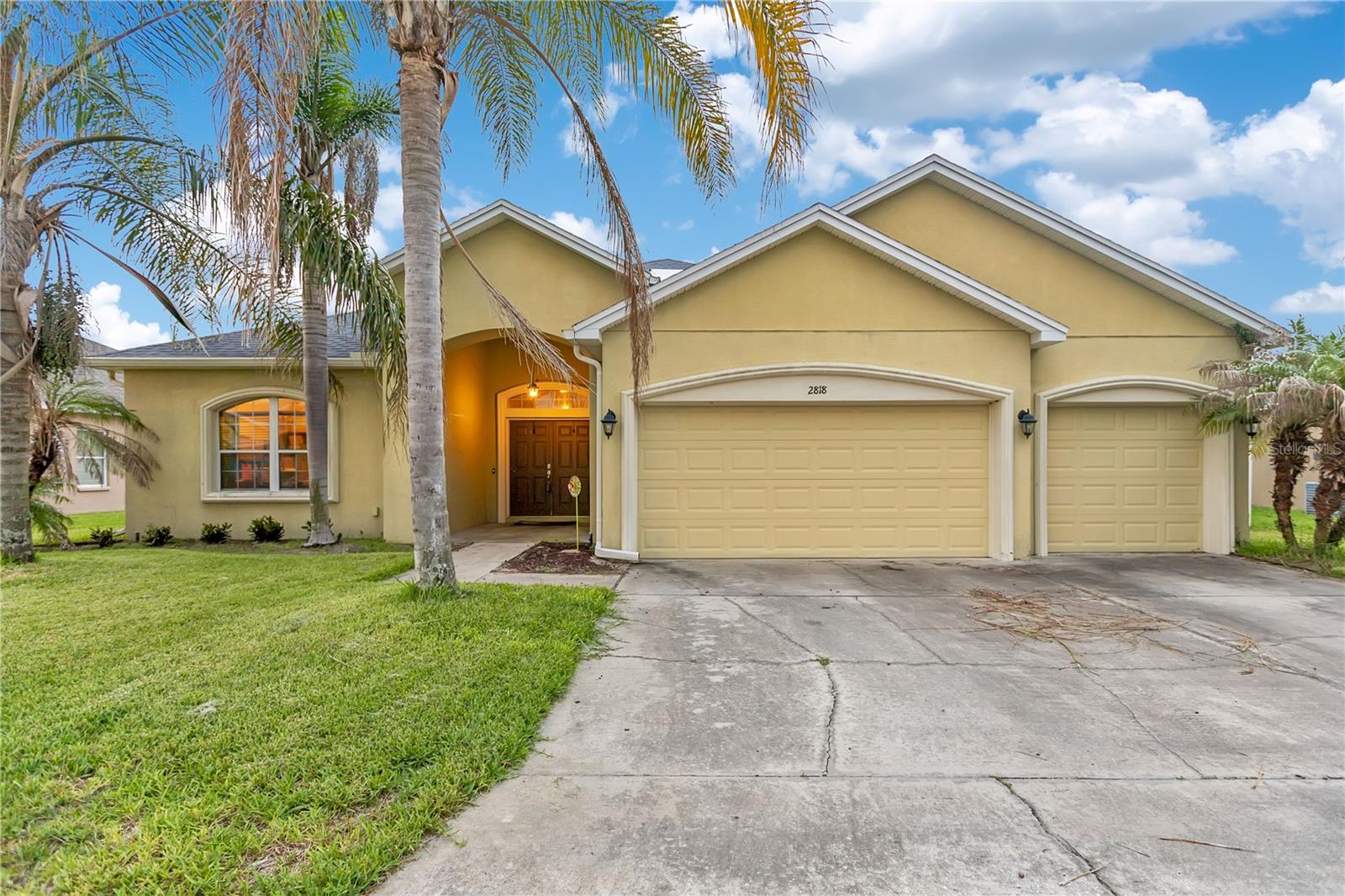 Welcome to this beautifully maintained South Lakeland home offering an exceptional combination of space, comfort, and style! Boasting 2,856 square feet, this spacious residence features 5 bedrooms, 3 full bathrooms, and a highly desirable split-bedroom floor plan designed for both everyday living and entertaining. From the moment you arrive, you'll appreciate the mature palm trees, extra-wide driveway, elegant double-door entry, and impressive curb appeal. Inside, you'll find stunning restoration oak flooring throughout much of the home, complemented by tile in the wet areas, creating a warm and timeless feel. The open kitchen is equipped with granite countertops, ample cabinetry, and overlooks the main living areas, making it perfect for gatherings with family and friends. The oversized primary suite is a true retreat, featuring double-door entry, an expansive bedroom, a luxurious en-suite bath with dual vanities, a spacious walk-in shower, and an enormous walk-in closet. Four additional generously sized bedrooms and two more full bathrooms provide plenty of room for family, guests, or a home office. Additional highlights include a separate indoor laundry room, a spacious 3-car garage complete with a workbench that conveys with the home, a covered lanai perfect for outdoor dining or relaxing, and a .23-acre homesite in a desirable gated community. Built in 2014 with a 2017 roof, this well-cared-for home is move-in ready and ideally located in sought-after South Lakeland, just minutes from shopping, dining, schools, and major roadways. Don't miss your opportunity to make this exceptional home yours!
