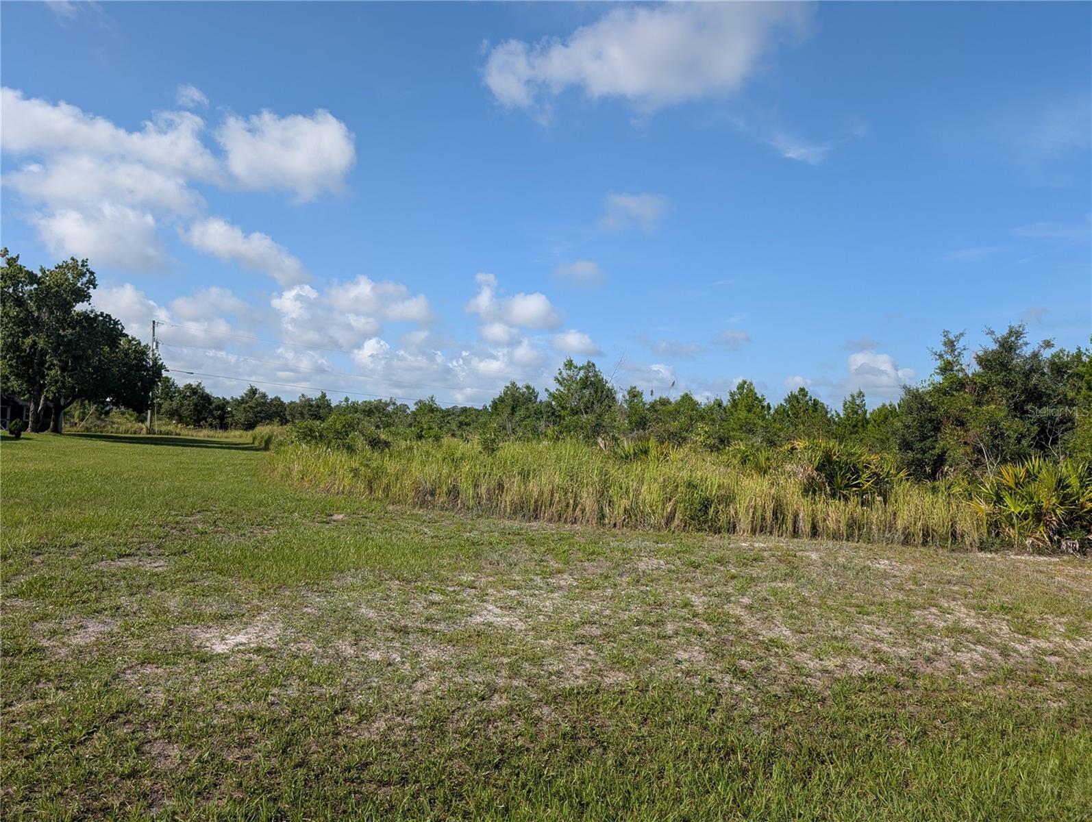 Exceptional 1/2 Acre Lot in Indian Lake Estates – Prime Location on a Great Street! Discover the perfect place to build your dream home in the highly sought-after Indian Lake Estates! Situated on one of the best streets in the community, this beautiful half-acre lot offers access to the community water system (no well required) and nearby electric service—making it ready for your custom build....Indian Lake Estates is a unique lake and golf community nestled about 20 miles east of Lake Wales in Central Florida. Centered around the stunning 7,500-acre Lake Walk-In-Water—renowned statewide and nationally for world-class bass fishing—this neighborhood is a true hidden gem. Residents enjoy exclusive lake access including a beach, boat ramp, marina, and the longest freshwater fishing pier in Florida. The lakeside pavilion offers propane grills and covered picnic areas for relaxing afternoons by the water....The community boasts impressive amenities including: An 18-hole golf course; Basketball and tennis courts; A 23,000 sq.ft. clubhouse with restaurant; Library, churches, post office, and fitness room, Pro shop and more...Nature lovers will appreciate the abundant wildlife, including deer, turkey, cranes, and a wide array of birds. Enjoy the peaceful country atmosphere with easy access to modern conveniences...Perfectly located just over an hour to Orlando, Disney World, and Tampa; Close to Bok Tower Gardens (National Historic Landmark), Minutes from Westgate River Ranch Resort, a 1,700-acre dude ranch with rodeos, airboat rides, horseback riding, glamping, and more...Whether you’re looking to build your forever home, a seasonal getaway, or an investment property, Indian Lake Estates offers an incredible lifestyle surrounded by nature, recreation, and charm. Come explore Polk County’s best-kept secret—Indian Lake Estates!