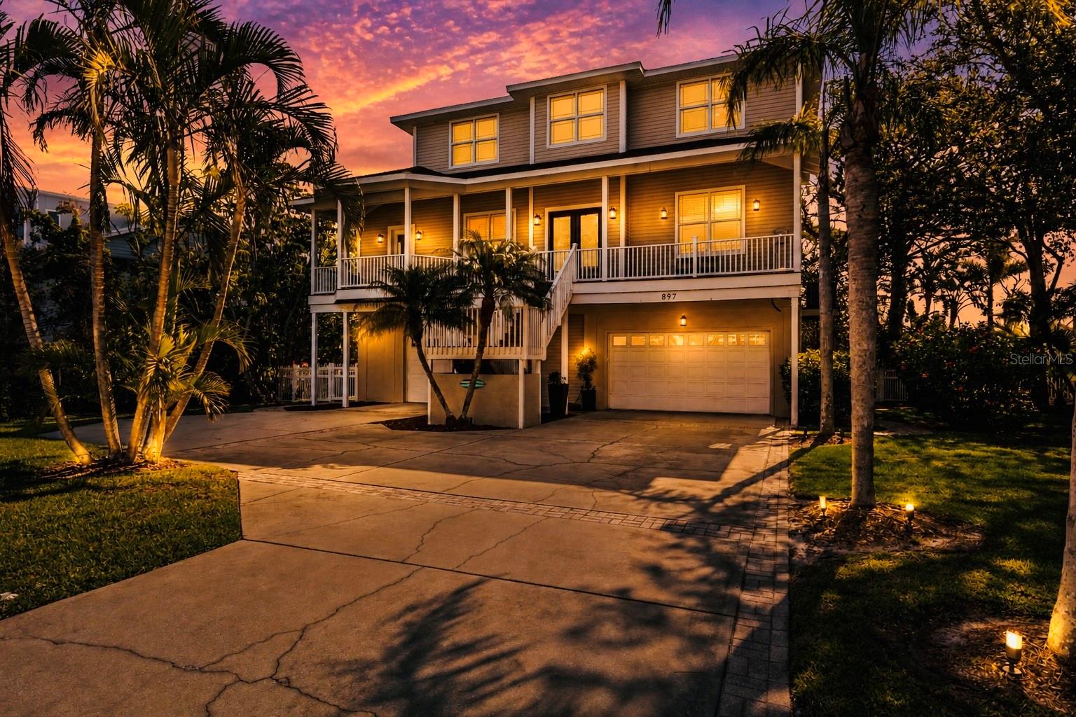 PRICE IMPROVEMENT - CRYSTAL BEACH LIVING AT ITS FINEST – A PRIVATE, ELEVATED COASTAL RETREAT. Tucked within the exclusive Point Seaside enclave of Crystal Beach – home to just 49 residences – this exceptional property offers a rare level of privacy, character, and luxury. Positioned just minutes from the Crystal Beach Pier and Live Oak Park, you’re immersed in a setting where breathtaking sunsets and a vibrant coastal lifestyle converge – complete with community events, waterfront gatherings, and the unmistakable charm of Old Florida. Perfectly situated to feel worlds away, yet minutes from the energy of downtown Palm Harbor, Honeymoon Island, and the Pinellas Trail connecting Dunedin to Tarpon Springs, this golf-cart-friendly community offers a lifestyle defined by simplicity, beauty, and connection. Days here are spent on the water, along scenic shoreline paths, or unwinding beneath glowing Gulf Coast skies. Spanning approximately 3,600 square feet, this 5-bedroom, 3.5-bath Key West-style residence with high-end finishes throughout is designed for both refined living and effortless entertaining. Soaring 10-foot ceilings and thoughtfully curated updates create a home that feels both elevated and inviting. At its heart, a fully reimagined chef’s kitchen serves as a true focal point - featuring an expansive island with quartz countertops, striking tile flooring, Café stainless steel appliances and a double oven setup – seamlessly flowing into the main living areas for a natural, open-concept experience. The spacious primary bedroom on the top floor features a walk-in closet with a California Closet system, two additional built-in closets, and an spa inspired en-suite bathroom with a separate soaking tub and shower. Outdoors, a private sanctuary awaits. A spacious covered balcony overlooks a lush nature preserve, offering a sense of seclusion rarely found in coastal communities. Below, the fully fenced backyard is a tropical retreat, complete with a pebble-tec pool, ambient landscape lighting, and a newly installed heater for year-round enjoyment. A front-facing balcony provides the perfect vantage point for evening sea breezes and the vibrant sunsets that define life on Florida’s Gulf Coast. A truly rare offering, the expansive 6-vehicle garage accommodates 5 cars plus a golf cart with ease, complemented by showroom-quality epoxy flooring and a dedicated 240V circuit for electric vehicle charging – ideal for collectors and enthusiasts alike. Elevated construction enhances both presence and peace of mind, with transferable flood insurance currently under $550 annually – and exceptional advantage for waterfront living. Additional enhancements include a 2022 Owens Corning roof system with lifetime shingles and storm guard underlayment, further reinforcing the home’s quality and longevity. Whether hosting under the stars, enjoying quiet mornings overlooking preserved land, or setting out for an evening along the water, this residence captures the essence of Crystal Beach living at its most refined. And the cherry on top? Crystal Beach is zoned for the most coveted schools in the area, including Ozona Elementary and Palm Harbor University! This isn’t just a home – it’s a lifestyle. And opportunities like this to own a piece of paradise in Crystal Beach don’t come around often.