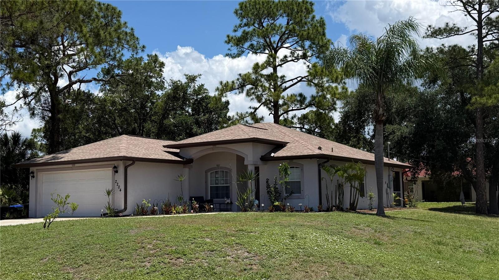 This cute traditional 3-bedroom, 2-bath home located on a corner lot featuring a shaded yard offers convenience to schools, shopping, and dining, with plenty of potential to make it your own.  The open-concept dining area flows seamlessly into the kitchen and living room, creating an inviting space perfect for entertaining family and friends. A split-bedroom floor plan provides added privacy, with the primary suite serving as a peaceful retreat featuring a walk-in closet and private shower. Enjoy peaceful backyard views from the dining area window or step through the sliding glass doors to a screened lanai and the rear yard. Additional highlights include an interior laundry area to keep chores comfortable year-round and a spacious garage offering extra storage and functionality. The property conveniently located near Heron Creek Golf & Country Club, Bobcat Trail Golf Club, and North Charlotte Regional Park. Great location with easy access to golf, parks, shopping, dining, and major roadways. The roof was replaced in 2024!
