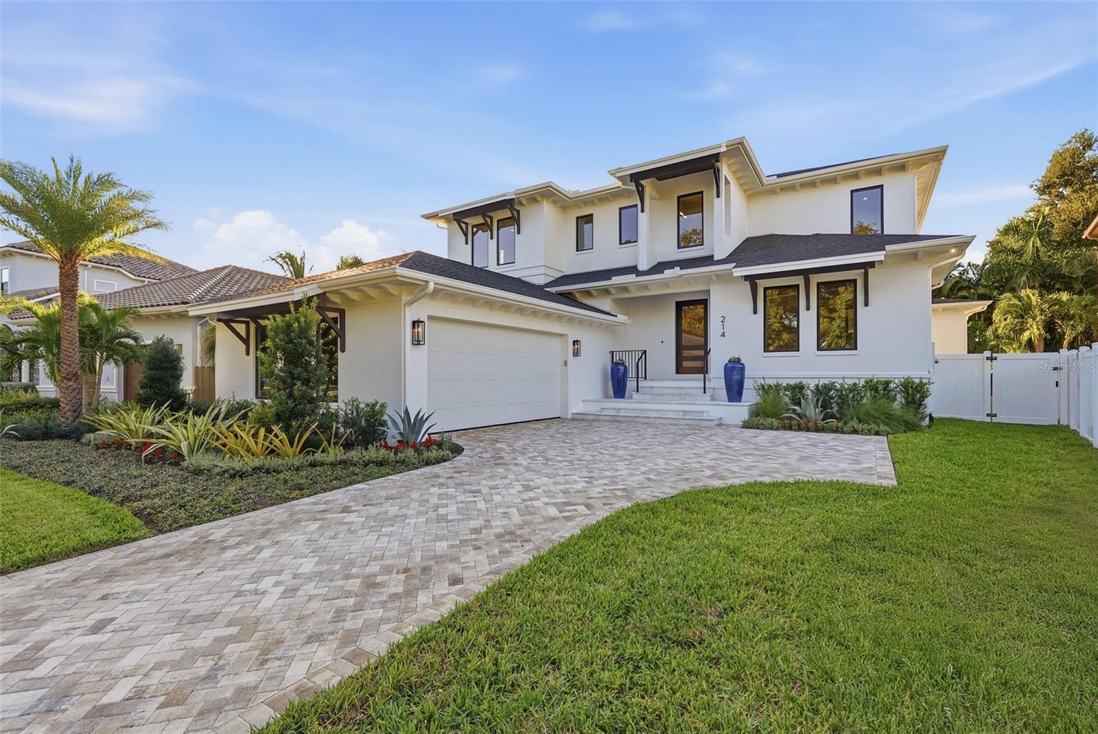 Newly constructed luxurious Coastal Contemporary estate home in beautiful Snell Isle crafted by Bayside Custom Homes. Perfectly positioned on a ¼-acre lot, this brand-new custom pool home includes 5 bedrooms, 6 full and 1 half baths plus office, including upper and lower primary suites for flexible living. The custom chef’s kitchen features quartzite countertops, custom maple cabinetry, Sub-Zero and Wolf appliances, a large island, and a butler’s pantry with prep sink and wine refrigerator. The open-concept great room, formal dining room, large breakfast area, and spacious office are designed for modern living and entertaining. Imported 9.5-inch brushed oak hardwood floors run throughout (except baths). Jeld-Wen Siteline bronze-clad wood impact doors and premium bronze impact windows provide strength, beauty, and efficiency. 8-foot 4-panel and multi-slide glass doors open to an expansive private outdoor oasis featuring cypress-paneled ceilings, a summer kitchen, and a 35 x 26 lanai overlooking an oversized 30’ x 15’ custom saltwater pool featuring spa and sun shelf with LED lighting, telescopic bubblers, and a 24x24 Akoya leathered marble pool deck. Additional features include hand-forged steel interior railings, full-height custom closets, and a two-car garage with EV charging station. Both primary suites include spa-inspired baths appointed with Waterworks and Brizo polished nickel plumbing fixtures, designer lighting, and custom finishes, while all secondary bedrooms are generously sized with ensuite baths. The home is plumbed for an optional bath in the study. Additional appointments include (2) Rinnai tankless recirculating water heaters, a smart-home pre-wiring package, designer lighting, and premium millwork throughout. From its open and airy layout to the seamless indoor-outdoor flow, this residence was designed for both comfortable family living and elegant entertaining. Located in the highly sought-after waterfront community of Snell Isle—one of St. Petersburg’s most desirable and historic neighborhoods—just minutes from downtown St. Petersburg, The Vinoy Golf Resort & Spa, upscale dining, shopping, museums, and waterfront parks. This exceptional Bayside Custom Homes residence perfectly blends craftsmanship, coastal elegance, and contemporary design to create the ultimate Florida luxury lifestyle.