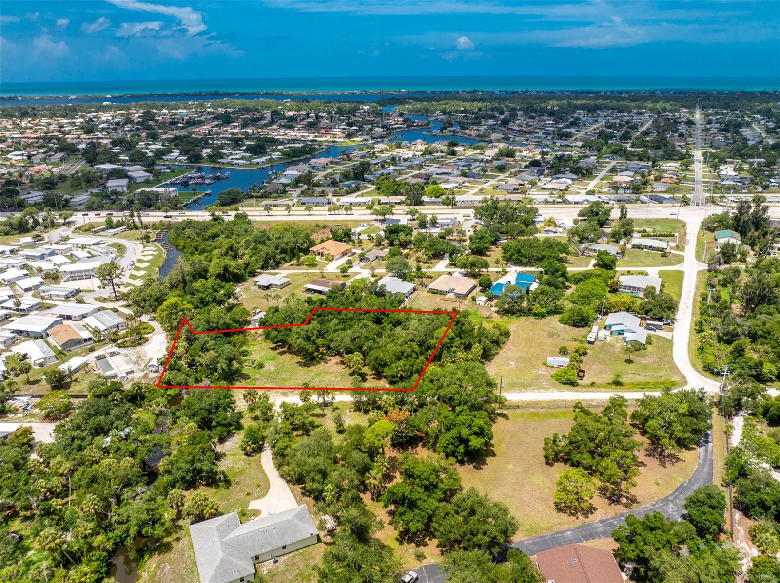 Rare opportunity to enjoy the feel of Old Florida with over an acre in a desirable North Englewood location. This 1.06 acre property offers a unique setting with a section of Forked Creek running through the southernmost portion of the land, creating the potential for peaceful kayak or canoe access toward Lemon Bay, all while enjoying natural surroundings and abundant Florida wildlife. The non-HOA setting provides added flexibility to create the lifestyle you have been looking for, with room to build your dream home, design additional outdoor living space, store recreational toys, or create your own private Florida retreat. Located approximately 3 miles from Manasota Key Beach and the public boat ramp, your days can be filled with boating, fishing, paddleboarding, waterfront dining, and sunsets along the Gulf shoreline. Enjoy easy access to shopping, dining, medical facilities, and everyday conveniences in Englewood, along with the charm of Historic Dearborn Street featuring local boutiques, restaurants, seasonal events, farmers markets, and community gatherings throughout the year. Just a short drive away, Wellen Park continues to grow with exciting new restaurants, shopping, gathering spaces, and entertainment options, while also being home to CoolToday Park, the spring training home of the Atlanta Braves and host to year-round events, concerts, and activities. Nearby Venice offers historic charm with its walkable downtown district, unique local shops, sidewalk cafés, art festivals, waterfront parks, beautiful Gulf beaches, and the area's famous shark tooth hunting. Enjoy the perfect balance of privacy and convenience while remaining close to everything Southwest Florida has to offer. Discover the possibilities waiting for you at this vacant parcel on 2nd Street in Englewood, Florida.