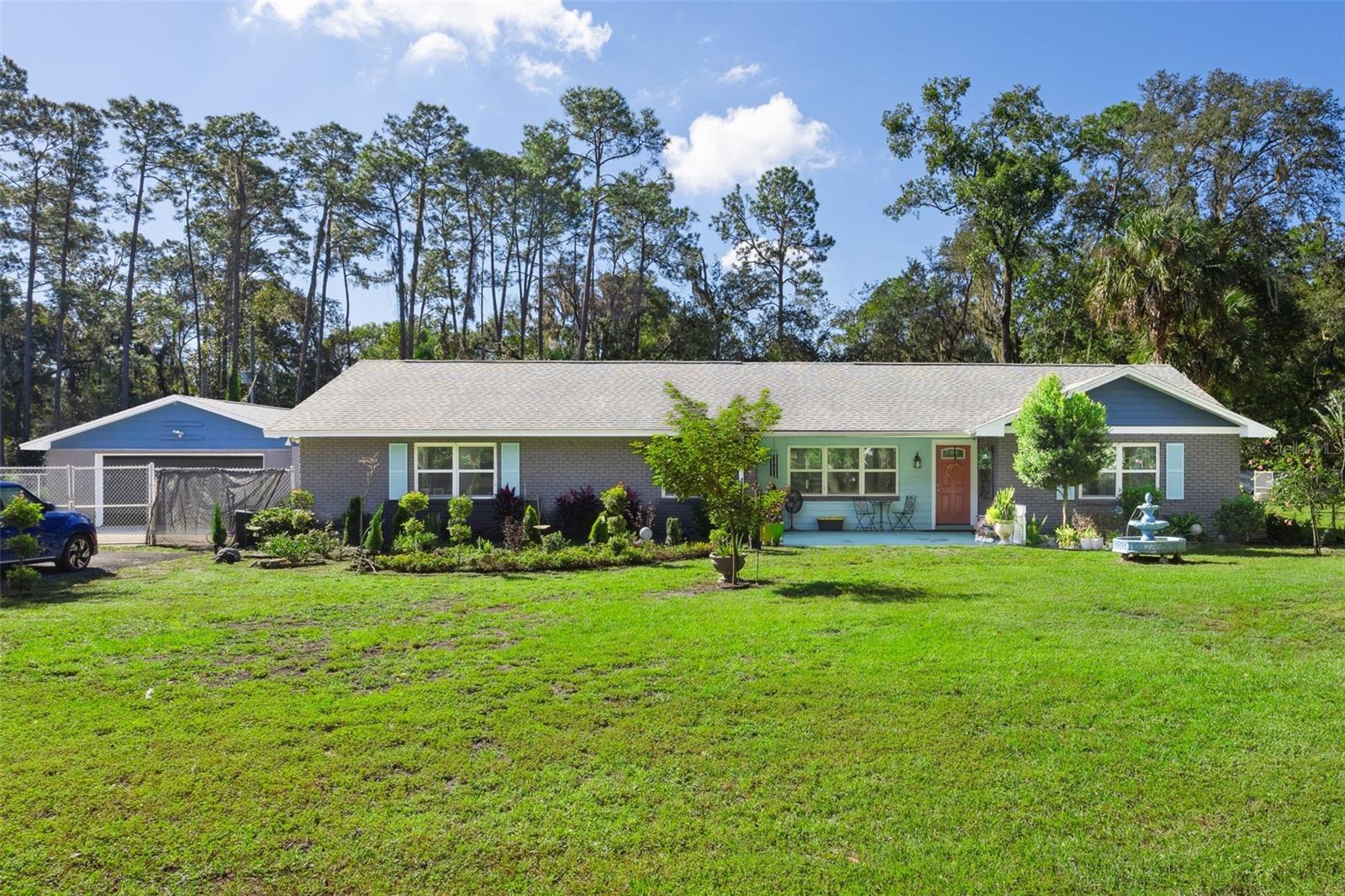 Welcome to 121 Herja Acre Lane, a spacious and well-maintained home set on a full acre with over 3,000 sq ft of comfortable living space. Inside, you'll find a large kitchen with granite countertops and a breakfast bar, an electric fireplace, and generously sized bedrooms—including a fourth bedroom that can easily serve as a second primary suite. Walk-in closets provide excellent storage throughout. Enjoy the outdoors with a fully fenced yard, a large back deck, a covered front porch, brick exterior, and a charming front fountain. Roof from 2016. The property also includes a detached 2-car garage, offering plenty of room for vehicles, tools, or a workshop. With its open layout, spacious rooms, and thoughtful upgrades, this home delivers the space and flexibility you're looking for.