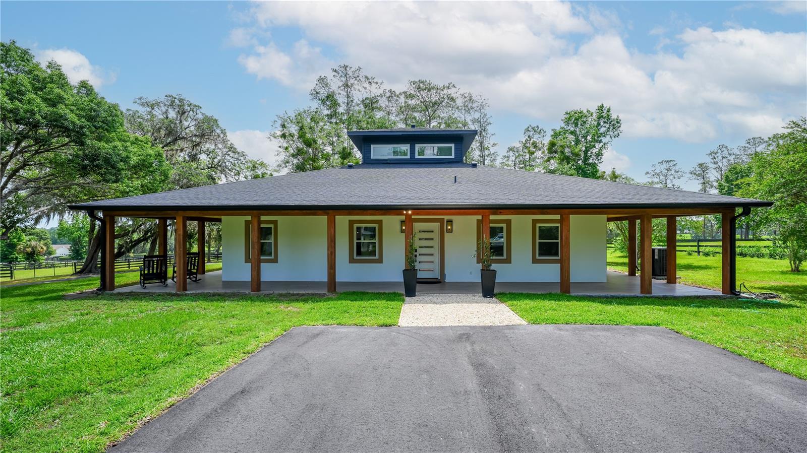 This move-in-ready, gated 5.58-acre farm is ideally situated along the highly desirable Highway 225 in the heart of Ocala’s renowned horse country. Located in the sought-after Northwest Ocala region, this property offers the perfect blend of modern comfort and equestrian living. Surrounded by established horse farms and free from HOA restrictions, the fully fenced property features lush paddocks with automatic waterers, mature shade trees, a natural pond, a gas fire pit, a generator, and a peaceful, private setting.

At the center of the property sits a beautifully updated American Four Square home with a distinctive belvedere and a wraparound porch, perfect for enjoying Florida’s year-round outdoor lifestyle. Offering 2,590 square feet of thoughtfully redesigned living space, the home includes 4 bedrooms, 2 bathrooms, and a den, all enhanced by high-end finishes throughout. The second-floor belvedere offers versatile living space with a closet, making it ideal as a fourth bedroom, home office, media room, or hobby space. Tile flooring extends through most of the home, while abundant windows fill the interior with natural light. An electric fireplace, decorative wood accents, and custom window treatments create a warm and inviting atmosphere.

The fully renovated kitchen is both stylish and functional, featuring stainless steel appliances, granite countertops, a tiled backsplash, ample cabinetry, a pantry, and a spacious center island. The open-concept design seamlessly connects the kitchen, dining, and living areas, creating an ideal space for entertaining family and guests.

Equestrian amenities include a solid three-stall concrete block barn with stall mats, tack room and a convenient walk-out design that opens directly to a large established pasture. It includes a natural pond equipped with an aerator and two paddocks. The acreage also provides ample room to add additional paddocks, an arena, or other equestrian improvements to suit your needs.

A separate one-bedroom, one-bathroom apartment located within the barn offers comfortable accommodations for family, friends, guests, or farm help.

Conveniently located just minutes from Highway 27, the property provides easy access to feed and tack stores, veterinary services, and equine professionals. Both HITS Ocala and the World Equestrian Center are approximately 10 minutes away, placing world-class equestrian competition and amenities within easy reach.

This is a rare opportunity to own a fully updated farm in the Horse Capital of the World®, where comfort, convenience, and exceptional equestrian living come together seamlessly.