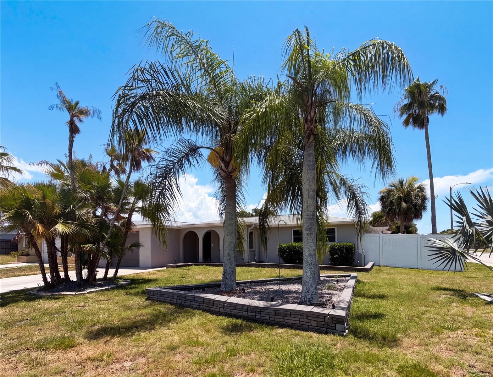 Virtually Staged. Welcome home to this beautiful 3-bedroom, 2-bathroom, 1-car garage home situated on a desirable corner lot in a community with no HOA or CDD fees. From the moment you arrive, you'll appreciate the attractive curb appeal, lush landscaping, and inviting exterior.  Step inside and be greeted by a bright, open floor plan featuring a neutral color palette and elegant plantation shutters that add warmth and character throughout the home. The spacious living room seamlessly flows into the dedicated dining area, creating the perfect space for both everyday living and entertaining.  The well-appointed kitchen offers quartz countertops, ample cabinet space, and a full appliance package, making meal preparation a breeze. Two generously sized secondary bedrooms share a full bathroom with a tub/shower combination, providing comfort and convenience for family and guests.  Toward the rear of the home, you'll find a versatile bonus room that can easily serve as a home office, playroom, hobby space, or potential fourth bedroom. The spacious primary suite features abundant closet space and direct access to the all-seasons room through large sliding glass doors, creating a private retreat to relax and unwind.  A second full bathroom is conveniently located off the kitchen, providing easy access for guests and household members alike.  Step outside to enjoy the fully fenced backyard, offering privacy, security, and plenty of space for outdoor activities, pets, or gardening. A side gate provides convenient access to the backyard, adding both functionality and ease of use.  Ideally located near US-19, this home offers quick access to shopping, dining, entertainment, medical facilities, and everyday conveniences. Don't miss your opportunity to own this charming and versatile home. Schedule your private showing today!
