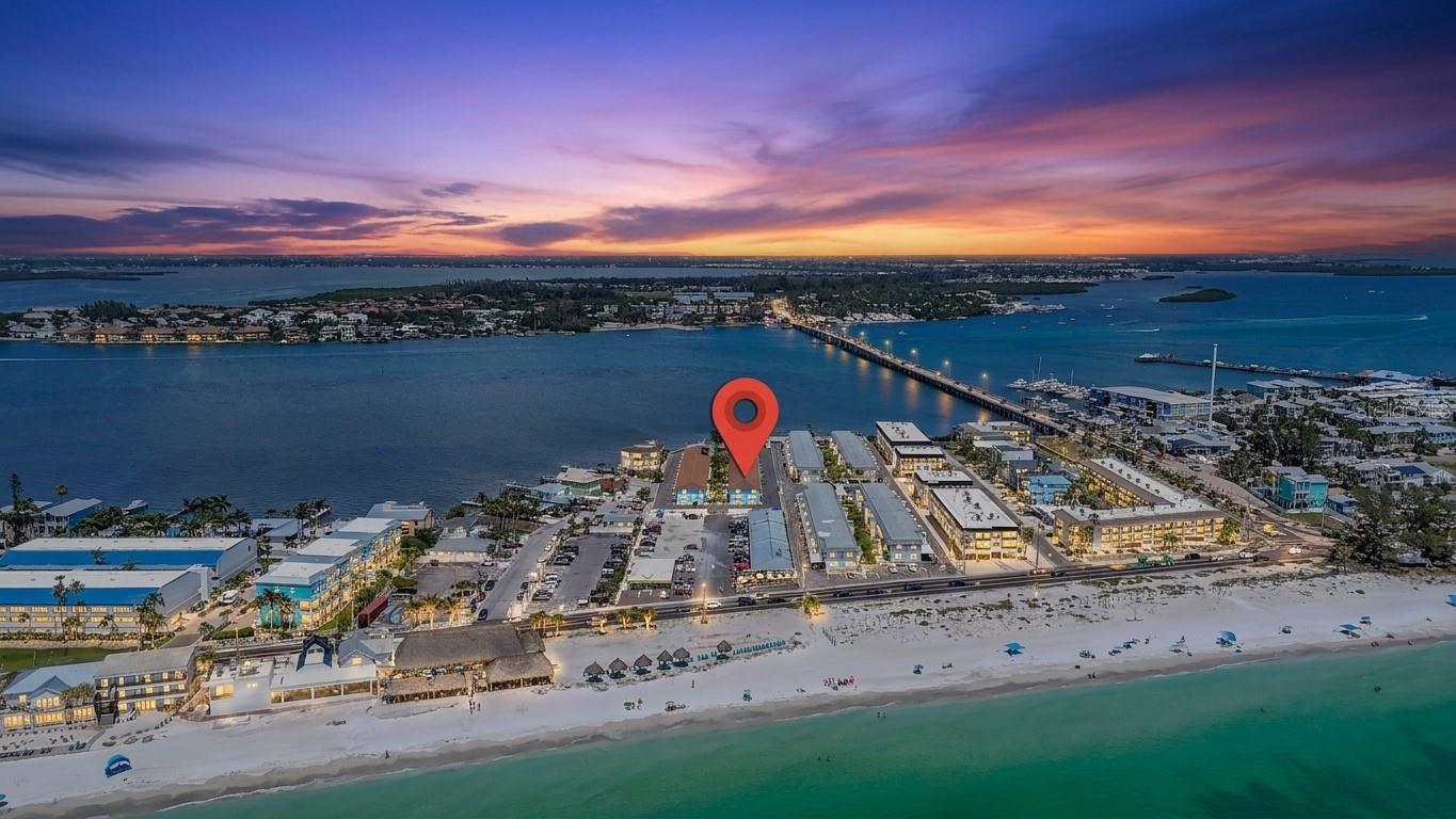 LOCATION!!! Dont miss this opportunity to own a beautifully remodeled first-floor condo in the highly sought-after Bayview Terrace community, where location truly is everything! Nestled directly on the bay and just steps from the sugar-white sandy beaches of the Gulf, this 2-bedroom, 1-bath unit offers the perfect blend of island living, convenience, and investment potential.

Completely renovated from top to bottom, this move-in-ready, turnkey furnished condo features a gorgeous upgraded kitchen with quartz countertops, stainless steel appliances, custom soft-close shaker cabinetry, and a breakfast bar perfect for casual dining and entertaining. Luxury vinyl plank flooring runs throughout the entire unit, creating a seamless, modern feel. Updated bathroom offers a quartz vanity and a tile-finished shower/tub combo. Both bedrooms are generously sized with plenty of room and comfort for owners and guests alike.

A rare feature within Bayview Terrace, this unit includes in-unit laundry for added convenience, as well as its own dedicated parking space located directly outside the back door. Being offered turnkey furnished, this property is ready for immediate enjoyment or rental income potential from day one.

Perfectly situated just steps from the community pool, beach access, and the vibrant atmosphere of Bridge Street, you'll enjoy easy access to some of Anna Maria Island's most popular restaurants, shopping, nightlife, and entertainment. Relax by the newly renovated waterfront pool overlooking the Intracoastal Waterway, where dolphins and manatees are frequent visitors.

Whether you're looking for a primary residence, vacation getaway, or income-producing investment property, this exceptional island retreat checks every box. Prime location, waterfront lifestyle, turnkey convenience, and fully updated interiors make this a rare opportunity you won't want to miss.