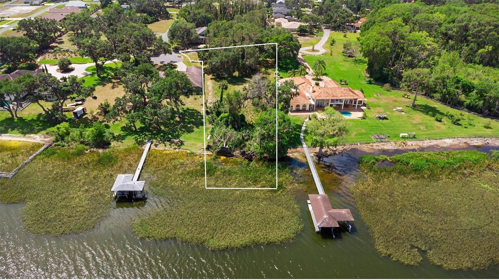 Create the lakefront lifestyle you've always envisioned on this stunning 1.64-acre homesite nestled on the shores of Lake Griffin. Located within the private, gated community of Majestic Oaks, this rare opportunity offers the perfect canvas for your custom dream home. Situated on Lake Griffin, a ski lake on the renowned Harris Chain of Lakes, your backyard becomes a gateway to endless adventures—including boating, fishing, and scenic cruises.  The Harris Chain of lakes connect to the Ocklawaha and St. Johns Rivers giving you so many places to go! This expansive lot offers a beautiful natural setting with mature trees and ample space to design an estate-style residence with sweeping views and room for outdoor living and entertaining. Whether you're envisioning peaceful mornings by the water, weekend boat rides, or elegant evenings under the stars, this homesite is ready to bring your dream to life. Don’t miss your chance to own a piece of waterfront paradise—schedule your private tour today and explore all the possibilities this exceptional property has to offer.