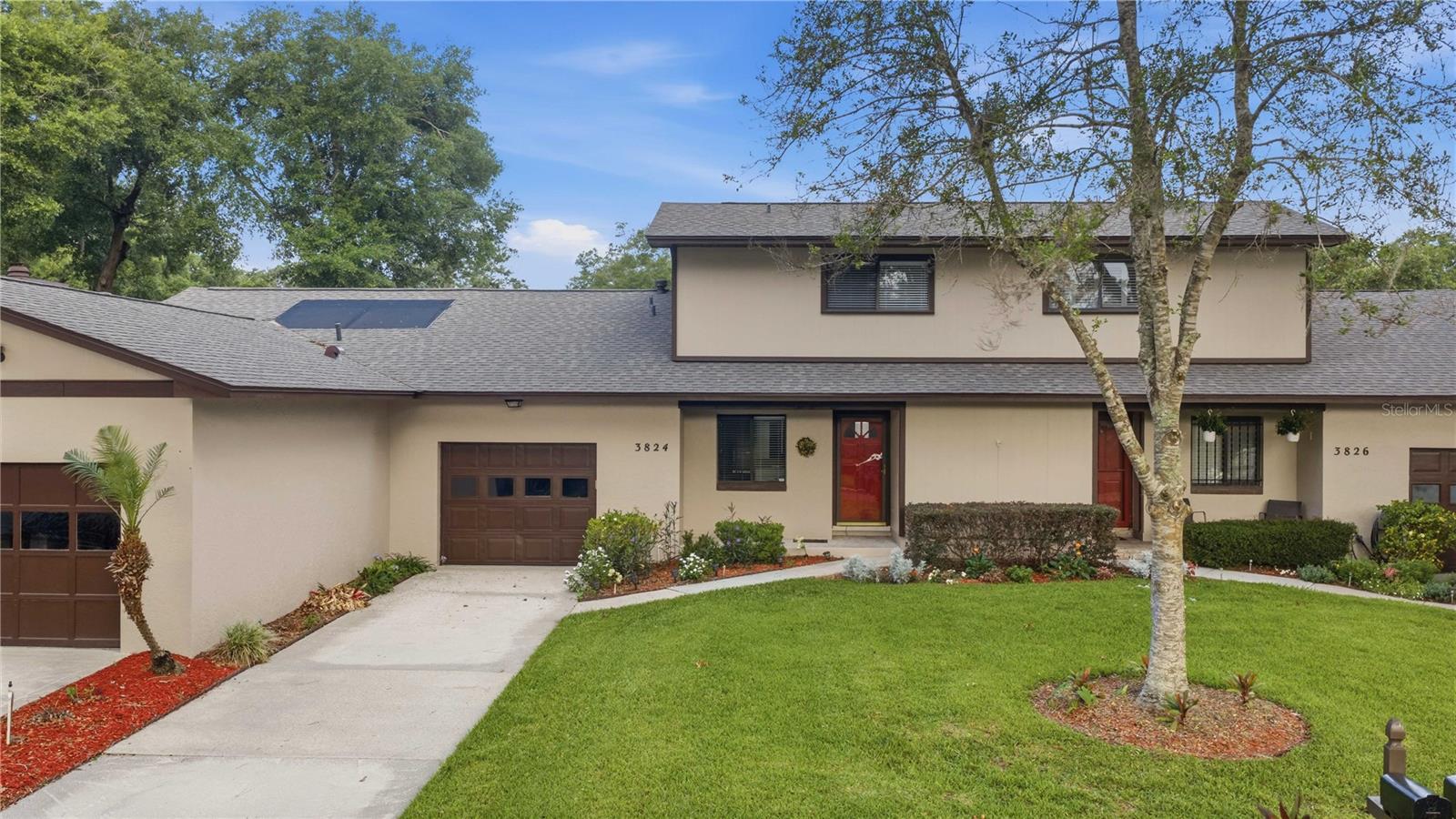 Beautifully designed two-story villa offering exceptional flexibility with dual primary suites—one conveniently located on the main level and another upstairs—making it ideal for multi-generational living, guests, or added privacy.

Move-in ready and thoughtfully updated, this home features a renovated kitchen, gorgeous wood flooring throughout the main living areas, and a spacious living room with soaring cathedral ceilings, exposed wood beams, and a warm, inviting wood-burning fireplace. The open-concept layout flows seamlessly into the dining area and includes a convenient pass-through to the kitchen.

The main-level primary suite is spacious and welcoming, featuring a walk-in closet, sliding glass doors leading to the enclosed back porch, and an updated en-suite bath with a beautiful walk-in shower. Upstairs, the second primary suite also offers a walk-in closet and private bath with a walk-in shower.

Additional main-floor highlights include a large storage closet beneath the staircase and a convenient half bath for guests. The enclosed back porch, complete with its own air-conditioning unit, adds approximately 308 square feet of versatile living and entertaining space. This area opens to a charming private courtyard, creating the perfect setting for outdoor relaxation.

Residents enjoy access to a community pool and pavilion, both included in the HOA fee. Conveniently located near shopping, restaurants, hospitals, and downtown Ocala, this villa offers comfort, convenience, and easy living at its finest.

This exceptional home is sure to impress!