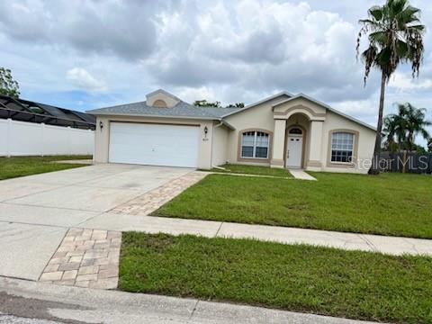 This home is located in desirable Wood Trail Village and has a serene and tranquil view of the pond. This  3 bedroom 2 bath 2 garage is X Flood Zone and no HOA requirement.   Home is well maintained and ready for it's new owner.  Roof was replaced in 2023, A/C was replaced 2025 and water heater is  2019.  There is lots of natural sunlight throughout this split bedroom plan.  Master bedroom includes a walk in closet and double sinks in master bath.  House has freshly painted interior and new paint on screened porch floor and garage floor.  This home offers both space and location.  Convenient to all amenities.