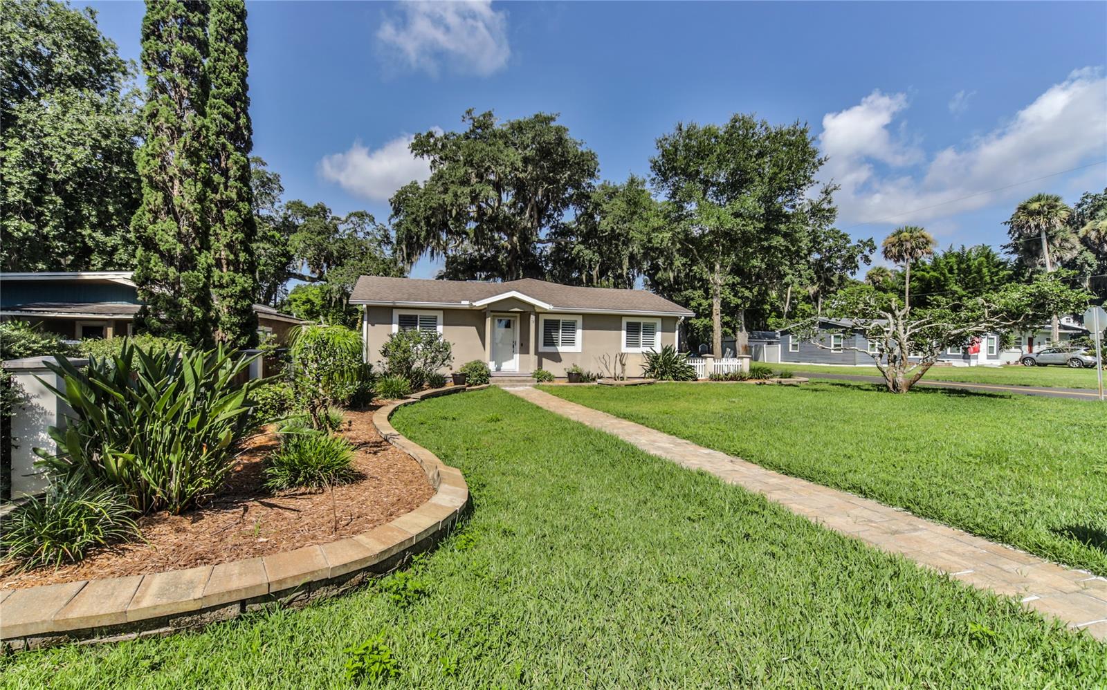 This wonderful light and airy home in the Riverside Park neighborhood of New Smyrna Beach is just what you have been looking for! Everything from top to bottom is CUSTOM to allow for an absolutely STUNNING appeal. This property is a HOME with carefully crafted finishes and top of the line materials used in every single aspect of its design. As you enter you will be greeted with beautiful vaulted ceilings, wood entry floors a split floor plan and newer paint. The kitchen complete with newer appliances, ceramic tile floors, sparkling granite counters and recessed lighting opens up to a LARGE family room with fireplace, cherry wood floors and ceilings - crafted by the homeowner.  Need some fresh air? Open the French doors just off the living room and enjoy the beautiful Florida weather in your screened in porch with ceiling fans. The Master bedroom has a walk in closet with an organizer and a private ensuite bathroom that offers a large walk in shower and corian vanity. The 2nd bedroom also has a ensuite bathroom with large walk in shower. The half bath is located just off the kitchen for guests!  Laundry room speaks volume with a sink and newer washer and dryer. The exterior of the home has a nice mix of grass and patio space, outdoor fire pit and a beautiful oak tree to create a shaded oasis. This home also features a detached 2 car garage which would be perfect for projects or storage. This home is a must see! and conveniently located in the New Smyrna Beach historical district. Situated on a LARGE lot, and walking distance to many great restaurants and shops! **All information is deemed to be accurate but not guaranteed** ;Water: City