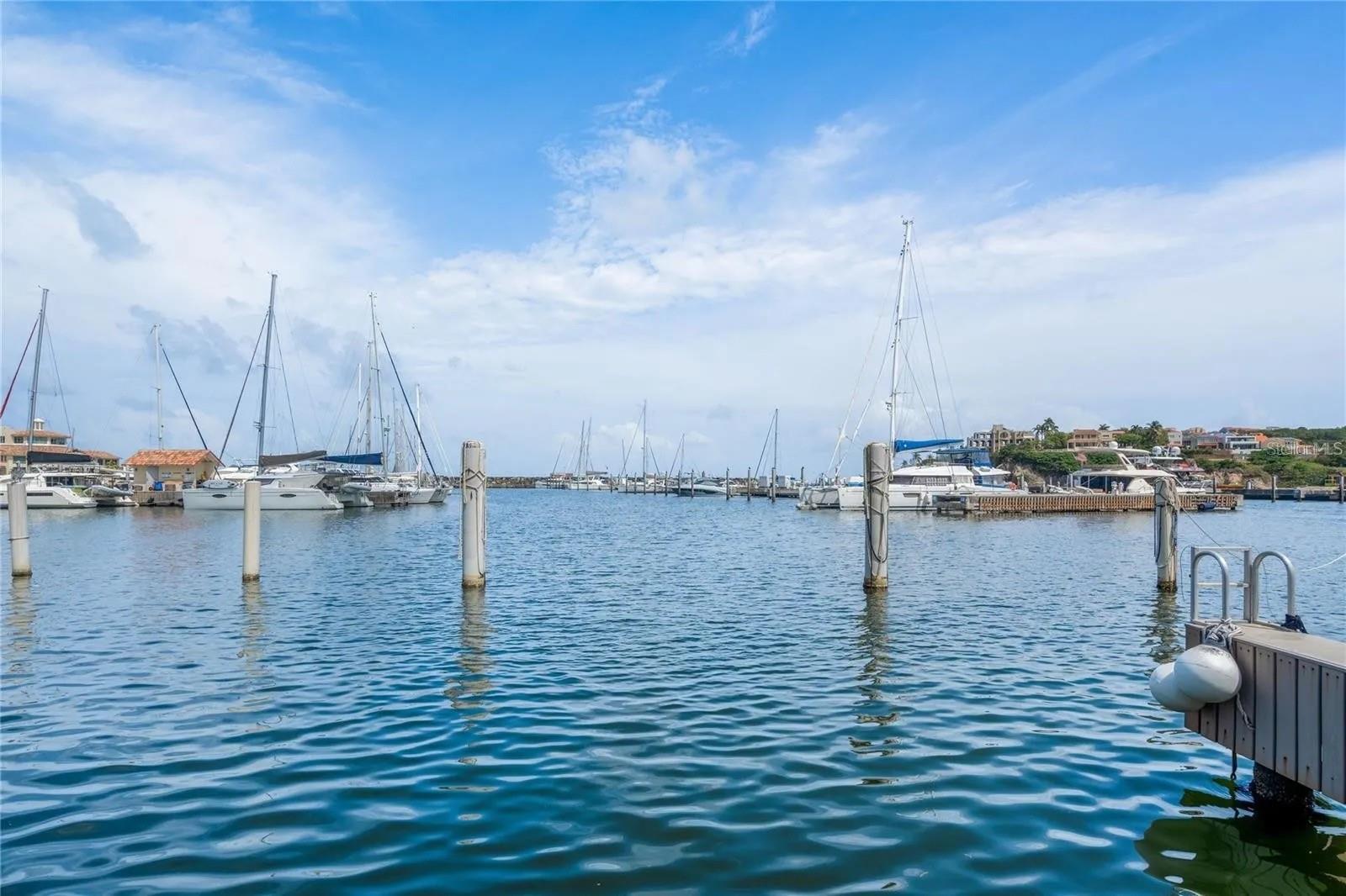 Waterfront Marina Living in Isla San Miguel, Palmas del Mar. Welcome to San Miguel 69 a rare waterfront residence in the private, gated Island community inside Palmas del Mar. Designed for boaters, water lovers, and anyone seeking true resort-style living, this three-level home offers a private boat slip, open living spaces, generous terraces, and direct views toward the marina, yacht club, and surrounding boats.

The residence features approximately 1,691 total square feet of GLA, plus terrace & balconies overlooking the private dock area. From here, enjoy an effortless coastal lifestyle with space for paddle boarding, kayaking, e-foiling, boating, and relaxed mornings by the water.

Inside, the home offers an open-concept kitchen and living area that flows naturally to the terrace, creating an easy indoor-outdoor setting for entertaining. The layout includes bedrooms distributed across the upper levels, with terraces positioned to capture east and west exposure. Solar panels add energy efficiency and support reliable day-to-day living.

Located within Palmas del Mar, residents enjoy one of Puerto Rico’s most complete resort communities, with gated neighborhoods, golf-cart-friendly streets, marina access, beaches, restaurants, parks, and club amenities nearby. Palmas Athletic Club confirms two championship 18-hole golf courses, while its racket center includes 12 hard courts, 4 clay courts, and 12 dedicated pickleball courts. The member Beach Club includes a pool area, water-play features, beach access, and family-friendly recreation.  

Palmas also offers natural beauty beyond the marina, including the Pterocarpus Forest Nature Reserve, a 51-acre preserve with a ¾-mile elevated boardwalk. The community includes the Wyndham Palmas Beach & Golf Boutique Resort, making it easy for visiting family and friends to stay nearby while still enjoying the privacy of a residential enclave.  

Whether used as a primary residence or second home, this Isla San Miguel property delivers the best of Palmas del Mar: boating, privacy, community, recreation, and the feeling of a Caribbean resort lifestyle every day.
