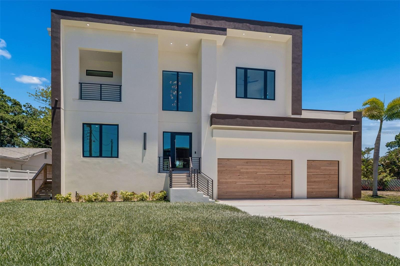Virtually Staged. Elevated construction, curated contemporary design, and cutting-edge smart home technology come together in this exceptional new residence designed for effortless modern living. A rare opportunity to own a newly completed architecturally striking modern home in the heart of Beach Park — one of South Tampa’s most coveted neighborhoods.

The home offers 6 bedrooms, 5 full bathrooms, 2 half baths, expansive open-concept living spaces, resort-style outdoor living, a brand-new pool, and a 3-car garage with elevator. Walls of hurricane-impact glass flood the interiors with natural light while creating a seamless connection between indoor and outdoor spaces — perfectly designed for the South Tampa lifestyle.

The designer kitchen is a true centerpiece, featuring Taj Mahal countertops, thermally fused wood laminate cabinetry, premium Thermador appliances, an oversized island, and a spacious walk-in pantry. Expansive sliding glass doors open to the covered lanai, outdoor kitchen, and pool area, creating an effortless indoor-outdoor experience ideal for entertaining and everyday living. This backyard is made for weekends grilling at the outdoor kitchen, dining poolside with friends and family, cooling off in the pool on warm afternoons, and enjoying the effortless luxury of year-round outdoor living.

The luxurious owner’s retreat offers dual walk-in closets and a spa-inspired bath with soaking tub, oversized shower, and refined designer finishes. Additional highlights include engineered hardwood flooring, porcelain tile, automated blinds, integrated security features, built-in speakers, TV pre-wire, and full smart home integration throughout.

Perfectly positioned in Beach Park and zoned for highly sought-after A-rated schools, this home places you minutes from Hyde Park Village, International Plaza and Bay Street, Midtown, Downtown Tampa, Tampa International Airport, and the Gulf beaches.