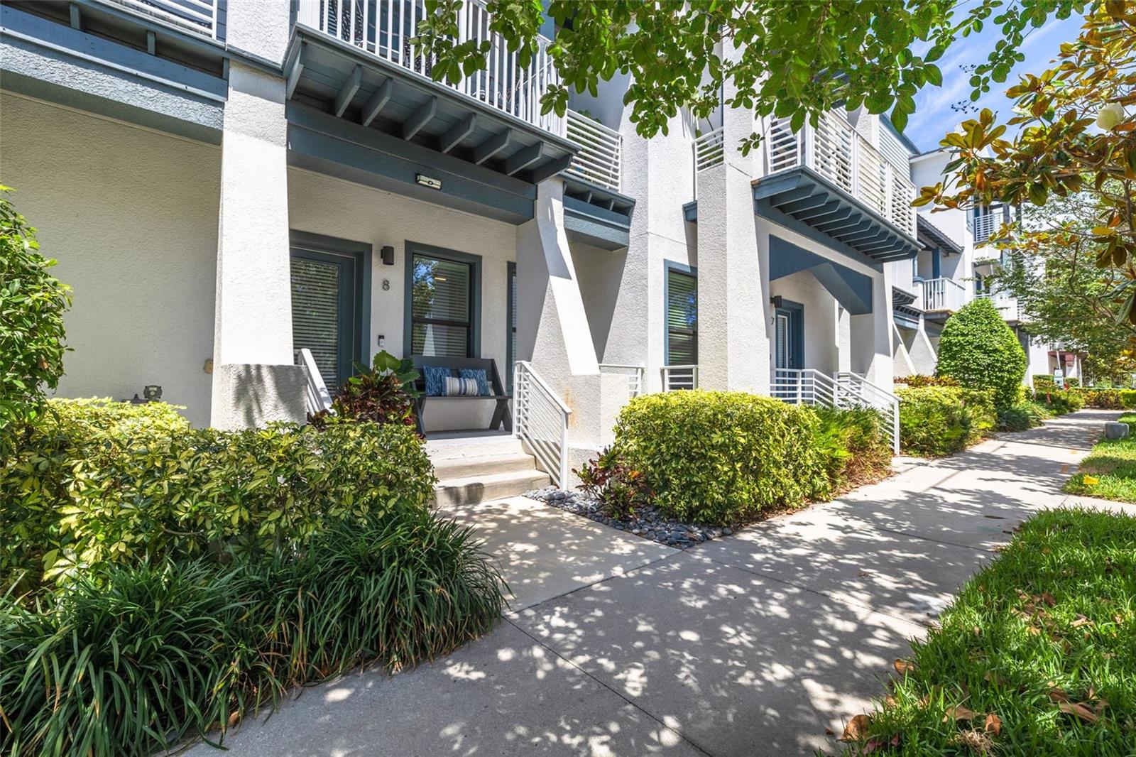 Built with solid block construction on all three levels, this newer townhome combines modern design and numerous updates completed over the last few years. From the moment you arrive, you'll be welcomed by a private ground-floor entrance with covered entry, tropical landscaping, and striking contemporary architecture. The first floor features a guest suite with its own full bathroom, making it ideal for visitors, a home office, or multi-generational living. This level also provides direct access to the attached two-car garage. The second floor serves as the heart of the home, offering an open-concept living space with soaring 10-foot ceilings, tons of natural light, and seamless flow for entertaining. The chef-inspired kitchen showcases beautiful cabinetry, marble countertops, a large center island, pantry, and gas range. A private balcony overlooks the quiet street below, creating the perfect spot to enjoy your morning coffee or unwind in the evening. The third floor is home to the spacious primary suite, complete with a large walk-in closet and a stunning spa-inspired bathroom. Also located on this level are the conveniently situated laundry area and a third bedroom with its own private full bathroom, providing comfort and privacy for family or guests. Residents also enjoy access to a beautifully maintained community courtyard featuring a BBQ and outdoor entertaining area, perfect for gathering with neighbors, hosting friends and family, or simply enjoying Florida's year-round sunshine. Beyond the home itself, you'll enjoy all that Dunedin has to offer. Consistently ranked among the most desirable cities in Pinellas County, Dunedin is known for its vibrant and walkable downtown filled with locally owned restaurants, craft breweries, boutique shopping, festivals, live music, and community events. Residents enjoy easy access to the waterfront, marinas, parks, and the Pinellas Trail, while world-famous Honeymoon Island and Caladesi Island are just minutes away. Whether you're biking boating, dining, or simply enjoying the coastal lifestyle, Dunedin offers a unique blend of small-town charm and year-round recreation. This exceptional townhome offers the perfect blend of luxury, location, and low-maintenance living in one of Tampa Bay's most sought-after communities.