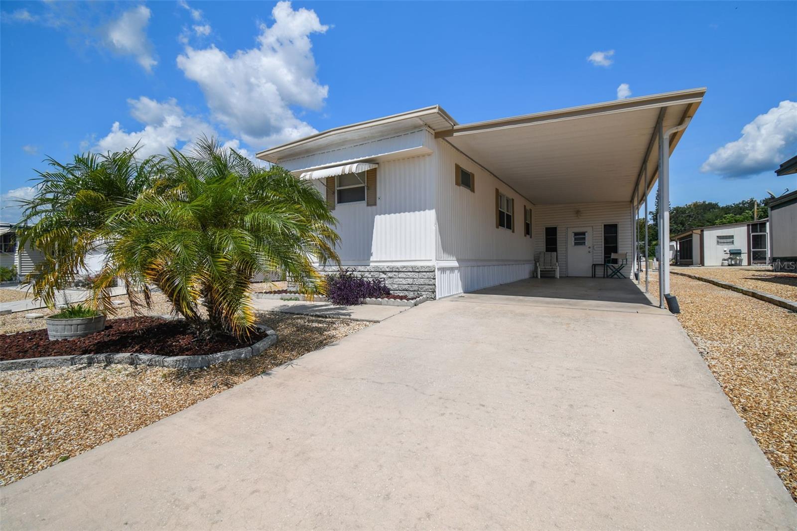 After a recent price reduction, this well-maintained home in Hudson’s Ponderosa Park is now one of the best values available in a 55+ community. The seller is motivated and ready for a smooth, no-hassle closing. Unlike many homes in the area, this property is not in a flood zone, sustained no storm damage, and does not require flood insurance—helping keep your monthly costs low and your peace of mind high. Located in one of the few communities where you own your land, this home offers long-term savings through low property taxes, no lot rent, and a remarkably low HOA fee of just $20 per month. The home itself features a 2-bedroom, 1.5-bath layout with a bright sunroom, a large shed with washer and dryer, and a zero-maintenance yard finished with decorative rock—perfect for snowbirds or anyone looking to simplify life. Residents of Ponderosa Park enjoy access to a heated community pool, shuffleboard courts, and a welcoming clubhouse. And just minutes away, Hudson Beach offers tropical bars, fresh local seafood, and beautiful Gulf sunsets. Tampa International Airport is less than 45 minutes away, making this location as convenient as it is comfortable. This home has been prepped, priced, and is now ready for its next chapter. Come take a look—you may find it’s exactly what you’ve been waiting for.