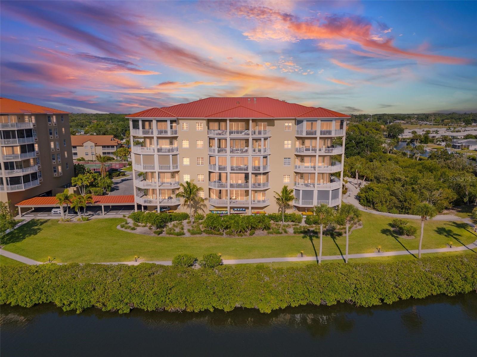 One or more photo(s) has been virtually staged. Experience elevated coastal living in this beautifully appointed waterfront residence, ideally located within the sought-after Blackburn Harbor community in Sarasota County.
Situated on the second floor (building with elevator), this elegant and spacious 3BR + den / 3BA condominium offers over 3,700 SF of a harmonious blend of style and comfort, complemented by serene water views. The open-concept layout features expansive living and dining spaces bathed in natural light, perfect for both everyday living and effortless entertaining. Sliding glass doors lead to a generous wrap-around lanai, creating a seamless indoor-outdoor setting to relax and enjoy tranquil water views, refreshing coastal breezes and spectacular sunsets.
The gourmet kitchen is as functional as it is inviting, showcasing rich wood cabinetry, granite countertops, stainless steel appliances, a center island for culinary enthusiasts, and a cozy dinette. A convenient breakfast bar opens to the main living area, ideal for casual dining and social gatherings.
The primary suite serves as a peaceful retreat, complete with ample closet space and a well-appointed en-suite bath. Each additional bedroom features its own en-suite bathroom and walk-in closets, offering comfort and privacy for guests or versatility for a home office.
Residents of Blackburn Harbor enjoy an array of resort-style amenities, including a heated pool, fitness center, clubhouse, tennis and pickleball courts, kayak storage and launch, and a gazebo with grilling areas. Boating enthusiasts will appreciate the protected deep-water dockage with power and water, and direct access to the Intracoastal Waterway with no bridges.
Surrounded by natural beauty, the community provides a front-row seat to Florida’s coastal wildlife, including dolphins and manatees. Just across the street, Oscar Scherer State Park offers scenic trails and outdoor recreation, while nearby waterways invite kayaking adventures to local favorites like Casey Key.
Perfectly positioned between Venice (10 minutes) and Sarasota (25 minutes), this location offers convenient access to shopping, dining, and cultural attractions, as well as world-renowned Gulf beaches, including Siesta Key Beach just 15 minutes away. Whether you’re seeking a seasonal escape or a year-round residence, this exceptional property captures the essence of Florida waterfront living.