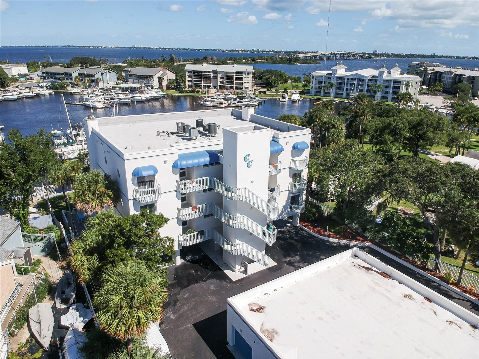 Tastefully renovated like a magazine editorial, this condo tells a story of coastal refinement & everyday ease. From sunrise reflections over Melbourne Harbor to moonlit views of the Indian River, every element inspires serenity & sophisticated living. Thoughtfully designed for comfort, it offers elevator access and ADA-compliant features, including a roll-in shower in the main bath. The owner's suite features convenient in-suite laundry with abundant storage cabinets. The kitchen shines w/ SS Bosch appliances, pull-out drawers, lazy Susan & sleek backsplash. Entertain at the wet bar beside the dining area or unwind in the great room by the stone fireplace. Sliders open to an oversized balcony where gentle breezes meet panoramic water views. Two deeded deep-water boat slips included! Use one & rent the other while enjoying an assigned parking, a private 1-car garage & separate storage. Steps from Melbourne Yacht Club, Historic Downtown's dining, shops, nightlife & 5 min to the beach!