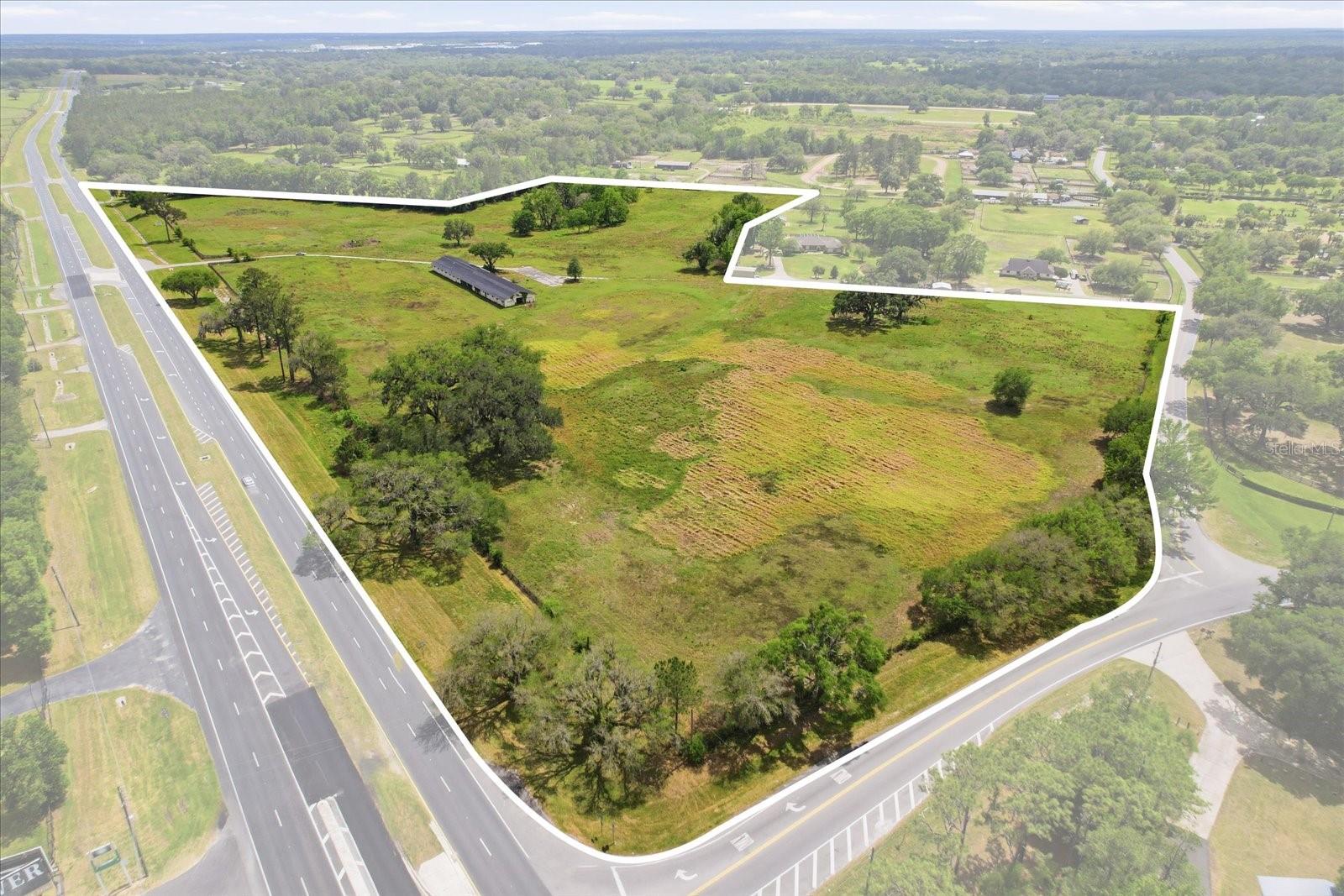This is a rare opportunity to step into a deal where the hard part is already done, the owner has invested the time and money to secure RAC zoning approval, eliminating months (or more) of uncertainty for the next buyer.
Featuring 2,121 feet of highway frontage, this property delivers the kind of visibility and access developers look for but rarely find. Even more compelling, the site directly backs up to the World Equestrian Center’s high-end residential developments, placing it in the immediate path of continued luxury growth and demand. The flexibility of RAC zoning opens the door to a variety of commercial or mixed-use concepts, allowing you to tailor the site to your vision.
Just 15 minutes from Downtown Ocala, this property sits directly in the path of growth. Strong frontage, strong zoning, and a seller who has already positioned the property for development. This is one you don’t want to overlook.