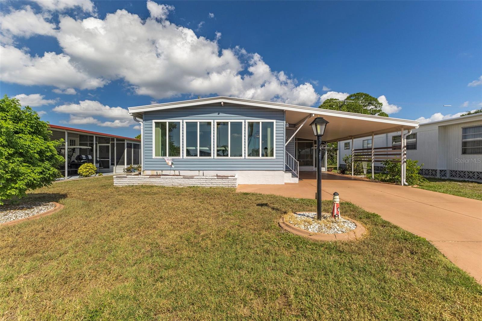 This inviting two-bedroom, two-bath home offers wonderful lake views. The expanded driveway brings you to a carpeted, vinyl-enclosed lanai. The utility room is equipped with a washer, dryer, deep sink, and plenty of storage. Step into the kitchen, where you'll find a breakfast bar, double pantry, extra half pantry, updated cabinets and countertops, stainless steel appliances, and a tiled backsplash. The tile work continues into the dining room, which also has extra storage. The spacious living room opens to a carpeted, glass-enclosed Florida room that overlooks the lake. The Florida room includes a wall A/C unit and a door leading to the carport. The guest bedroom has a double closet, and the guest bathroom features an updated vanity and a tiled walk-in shower. In the hall, there are two utility closets and a linen closet for additional storage. The large primary bedroom includes two walk-in closets, and the ensuite bathroom has an updated vanity and a tiled walk-in shower. Recent upgrades include a new roof in 2024, newer appliances, cabinets, countertops, and updated floorLa Casa is an enchanting community where 974 home sites are beautifully set among native trees, surrounded by spacious common areas and eight serene lakes. La Casa is conveniently located between Sarasota and Fort Myers. Enjoy easy access to shopping, sightseeing, golfing, and fishing, all the while immersing yourself in the rich culture of Southwest Florida. Experience the warmth of Southwest Florida's winters in a relaxed environment, far from the east coast hustle. Our lush, mature landscaping reflects the dedicated care of our residents and management. Stay connected with our complimentary Wi-Fi at the Clubhouse, Activity Building, and Recreation Hall while you soak up the sun. La Casa is a family-friendly haven where you can enjoy tranquility while remaining close to vibrant attractions. Come visit our charming oasis and discover why La Casa is the ultimate destination for snowbirds and year-round residents!ing in key areas.
