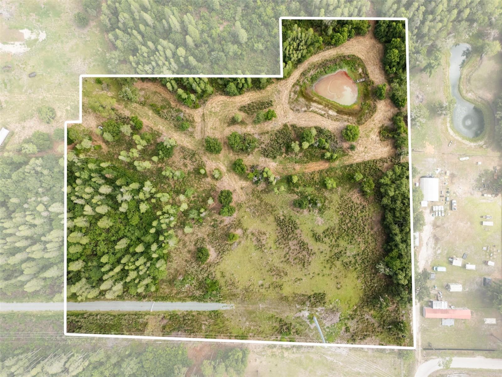 This massive 9.51-acre master parcel offers an uninhibited canvas for your ultimate dream estate, family compound, or long-term land investment. If you are looking for true privacy, mature natural beauty, and room to breathe, this is the rare acreage you have been waiting for. Located at the end of a quiet, unimproved road in the established Ko's Estates subdivision, you get maximum privacy with zero through-traffic. Build with absolute peace of mind. The property sits entirely in a LOW RISK flood zone, meaning no mandatory flood insurance is required by lenders. Enjoy the perfect balance of rural tranquility and suburban convenience. You are just minutes away from North Lakeland’s premier shopping, dining, and excellent school districts, with fast, seamless access to the I-4 corridor for easy commuting to both Tampa and Orlando.