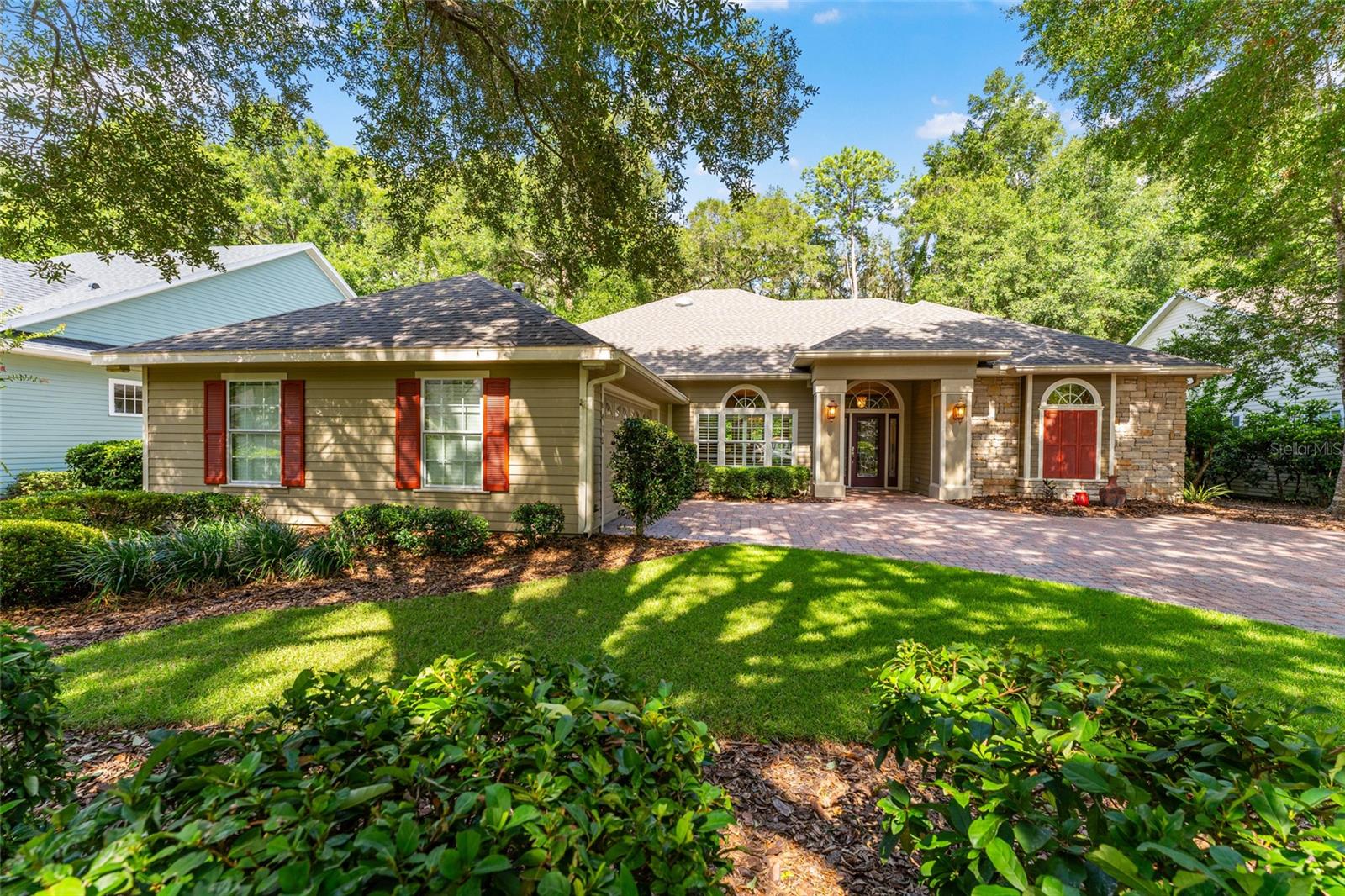 Former Wilde Parade Home backing to the historic Old Haile Homestead! Perfectly positioned on one of Eloise Garden's most picturesque lots, this beautifully maintained 3-bedroom, 2-bath home blends timeless craftsmanship with exceptional privacy and an unbeatable location just moments from Haile Village Center. 

From the moment you arrive, you'll appreciate the lush landscaping, elegant paver driveway, and inviting curb appeal. The association-maintained front yard allows for low-maintenance living while enhancing the neighborhood's beautiful streetscape. 

Inside, rich Brazilian cherry hardwood floors flow throughout the main living areas, complemented by extensive crown molding, custom built-in cabinetry, and a cozy gas fireplace that anchors the spacious great room. 

Designed for both everyday living and entertaining, the kitchen features granite countertops, stainless steel appliances, a gas range, abundant cabinetry, and a sunny breakfast area overlooking the private backyard. The formal dining room is a true showpiece with its stunning hand-painted tray ceiling mural, creating an unforgettable setting for holidays and dinner parties. 

The spacious primary suite offers a peaceful retreat with an elegant ensuite bath featuring a large soaking tub, walk-in shower, dual vanities, and generous storage. Two additional bedrooms provide flexibility for guests, family, or a home office. 

One of the home's standout features is the expansive screened lanai, offering the perfect place to enjoy morning coffee, outdoor dining, or quiet evenings while overlooking the serene natural setting bordering the Old Haile Homestead. 

Recent major updates provide peace of mind with a new roof and HVAC system installed in 2025. 

Located less than one mile from Haile Village Center, you'll enjoy easy access to local restaurants, coffee shops, boutiques, and the popular Saturday Farmers Market, all while living in one of Gainesville's most convenient locations. 

This is a rare opportunity to own a former Parade Home in an exceptional location where quality, character, and lifestyle come together beautifully.