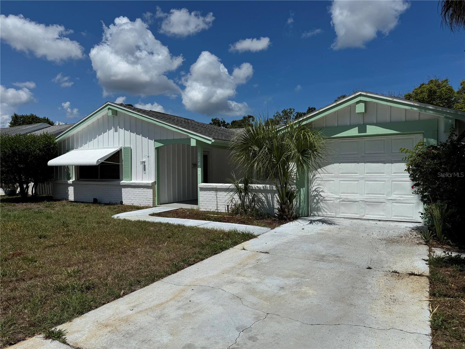 Welcome to the highly desirable Beacon Woods golf community where Lifestyle Meets Location! This family home offers 3 bedrooms, 2 full bathrooms, and a 1-car garage. The light and bright interior is complemented by great closet space and tile flooring throughout the house. The split-bedroom floor plan offers privacy for residents and guests. The sliding glass door leads to the screened patio, creating seamless indoor-outdoor living and an ideal space for relaxing or entertaining. Beacon Woods residents enjoy an array of amenities including a heated swimming pool, tennis courts, basketball and pickleball courts, gym and playground. Conveniently located near US 19, SR 52, and Little Road, this home provides easy access to golf course, shopping, dining, and local hospitals and medical centers—an exceptional opportunity to enjoy spacious living in a well-established community.