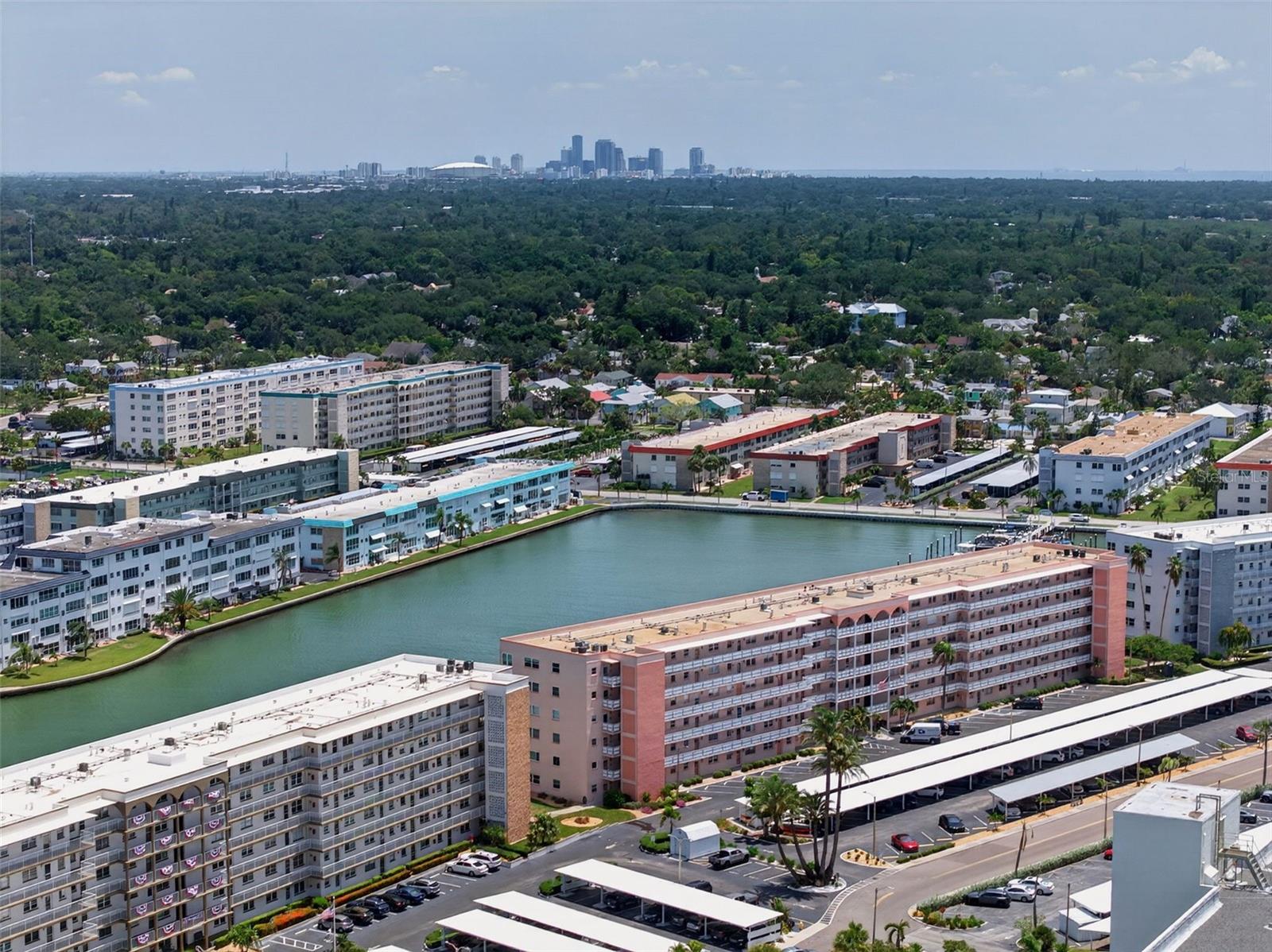 Virtually Staged. Welcome to Town Shores’ desirable Manchester Building, where spectacular sixth-floor water views create the perfect backdrop for Florida living. From the moment you step inside this beautifully maintained 2-bedroom, 2-bath residence, you’ll be captivated by the sparkling waterfront vistas visible through the open floor plan. Watch dolphins and manatees play from the comfort of your own home, and even catch a glimpse of the iconic Don Cesar Hotel in the distance.
Offering approximately 1,250 square feet, this light-filled condo features tile flooring throughout, creating a seamless flow from room to room. The inviting kitchen offers timeless appeal with crisp white cabinetry, neutral Corian countertops, and a gas range. The spacious primary suite includes an updated en-suite bathroom with a walk-in shower, while the guest bedroom is conveniently located next to the beautifully updated hall bath.
Adding to the value, the Manchester Building allows immediate rentals (subject to the community’s rental cap and availability), making this an excellent opportunity for seasonal residents, investors, or full-time homeowners.
Town Shores is one of Gulfport’s premier 55+ waterfront communities, offering an exceptional resort-style lifestyle with four heated pools, tennis courts, pickleball, shuffleboard, a clubhouse, fitness opportunities, and a full calendar of social activities. Stroll or bike to vibrant downtown Gulfport, where you’ll enjoy award-winning restaurants, waterfront parks, galleries, live entertainment, the popular Tuesday Fresh Market, and the city’s signature eclectic arts scene.
This residence also includes covered, assigned parking and a private storage unit. Whether you’re searching for the perfect winter retreat or a year-round waterfront lifestyle, this exceptional condo offers breathtaking views, outstanding amenities, and everything that makes Gulfport one of Florida’s most beloved coastal communities.