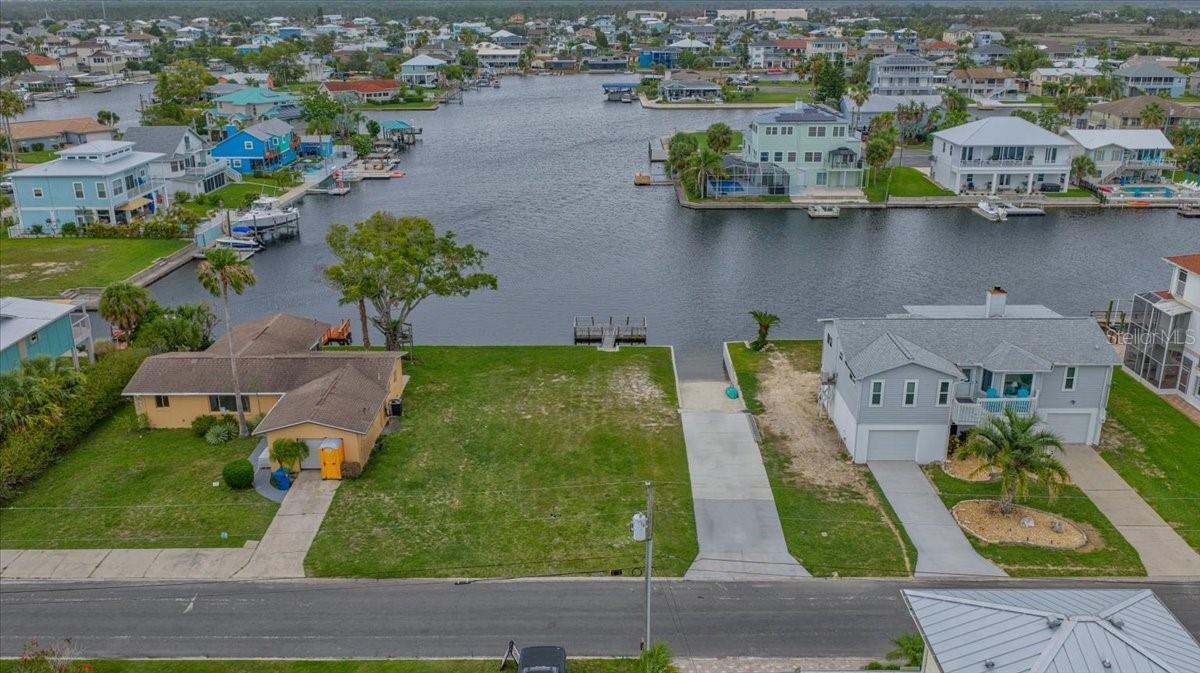 DIRECT GULF ACCESS • PRIVATE BOAT RAMP • CONCRETE SEAWALL • DEEP WATER CANAL Rare opportunity to own a 7,400-square-foot (74x100) waterfront homesite in the highly desirable coastal community of Hernando Beach. Featuring its own private boat ramp, concrete seawall, and direct Gulf access, this exceptional property is perfectly positioned on a deep-water canal with quick access to the open Gulf of Mexico, making it a dream location for boaters, anglers, and waterfront enthusiasts. Build your custom elevated coastal home and enjoy the ultimate Florida waterfront lifestyle with boating, fishing, kayaking, paddleboarding, and breathtaking water views right from your backyard. With no HOA, no deed restrictions, and no short-term rental restrictions, this property offers outstanding flexibility for a primary residence, vacation home, or investment property. Zoned R1B for single-family homes only (no mobile or manufactured homes permitted). The property is located within a flood zone, and future construction will require an elevated home in accordance with current building requirements. There is no time limit to build, allowing you to purchase now and develop at your own pace. Public water, sewer, and electric service are available at the street for future connection. Please note this is not an RV lot, and RV living is not permitted. Conveniently located near waterfront restaurants, marinas, shopping, entertainment, and everyday conveniences, Hernando Beach offers a unique blend of coastal living and Old Florida charm. Nearby Weeki Wachee Springs State Park provides endless opportunities for kayaking, paddleboarding, boating, and exploring Florida's natural beauty. Don't miss this rare opportunity to own a Gulf-access waterfront lot with a private boat ramp in one of Florida's premier boating communities. The property is located on the right side of the road just past 4168 Orchid Drive. Land financing options may be available. Lot lines shown in aerial photographs are approximate. Please do not walk on the floating dock.