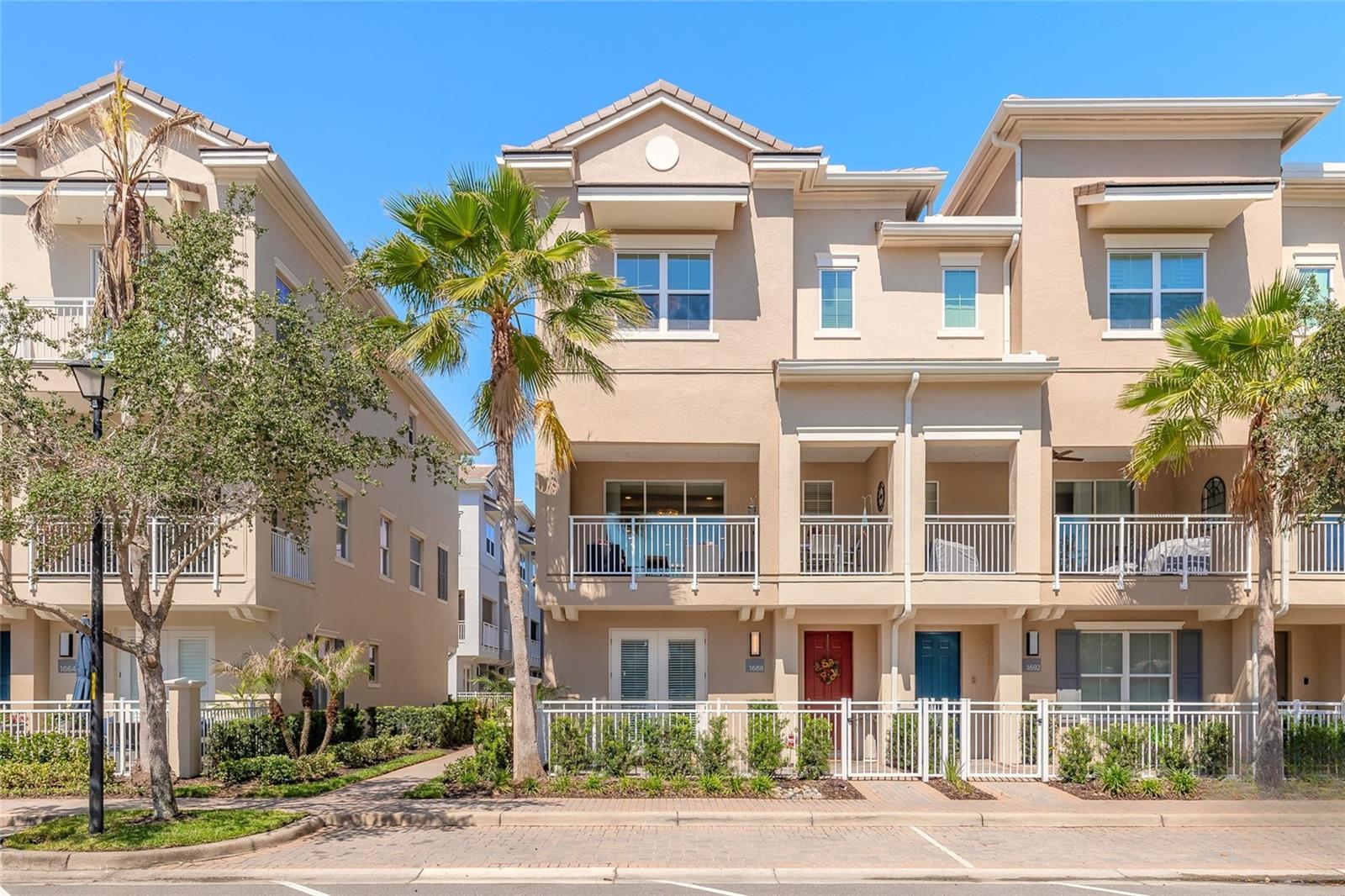 Some homes check the boxes. This one raises the standard. Located inside the gated community of Grande Oaks at Heathrow, this extensively upgraded end-unit townhome delivers the kind of finishes, layout, and location that buyers wait for in Lake Mary. From the moment you walk in, it’s clear this isn’t the builder-basic version of the Magnolia model. The first level offers a flexible bonus room with a full bath, access to the rear-facing 2-car garage, and double French doors leading to a private paver bistro patio that feels tucked away from it all. Whether used as a home office, guest retreat, gym, or additional living space, the layout offers flexibility without sacrificing style. Upstairs, the main living area was designed for both entertaining and everyday life, featuring engineered hardwood flooring, crown molding, coffered ceilings, and natural light pouring through newly installed windows. The gourmet kitchen feels straight out of a custom renovation project with upgrades rarely found in this community. Features include GE Café Series appliances with induction cooktop, convection wall oven and microwave, warming drawer, Monogram wine refrigerator and vent hood, quartz countertops, glass backsplash, custom 42-inch soft-close shaker cabinetry with pull-out organizers, recessed lighting, and an oversized espresso-wrapped island designed for gathering. The spacious balcony extends the living area outdoors and offers peaceful water views that make morning coffee feel a little more expensive in the best way. The 3rd floor includes 3 bedrooms, 2 full baths, and a laundry area featuring a GE Profile Ultra-Fast ventless heat pump washer/dryer combo. The primary suite features coffered ceilings, a large walk-in closet, and a beautifully upgraded spa-inspired bath with quartz counters, dual vanities, designer fixtures, frameless glass shower enclosure, rainfall shower head, and elevated finishes throughout. Additional upgrades include Cat-5 wiring, upgraded porcelain tile, designer lighting, LED lighting throughout, MyQ-enabled garage access, custom hardware, and extensive high-end finish selections totaling more than $120,000 in upgrades and improvements. Even better, the heavy lifting has already been done. Grande Oaks is currently undergoing a multimillion-dollar community enhancement project that is already more than two-thirds complete, with no special assessment. Completed updates to this building include new windows, clay tile roof, stucco, exterior paint, balcony restoration and waterproofing, gutters, railings, lighting, landscaping, and French drain systems. Community improvements also include updated pergolas, fencing, signage, LED lighting conversion, SmartCity fiber optic internet included through the HOA, MyQ guest and resident gate access, and future road resurfacing once renovations are complete. Residents enjoy gated access along with a clubhouse, fitness center, resort-style pool, and walkability to Colonial TownPark dining, shopping, and entertainment, with quick access to I-4 and SR-417. Offering approximately 2,187 square feet with 3 bedrooms, 3.5 bathrooms, bonus room, multiple outdoor living spaces, and a rear-entry 2-car garage, this is elevated townhome living in one of Lake Mary’s most connected locations. Shown by appointment only. All information is deemed reliable but not guaranteed and should be independently verified by buyers and buyers’ representatives. This property is under audio and visual surveillance.